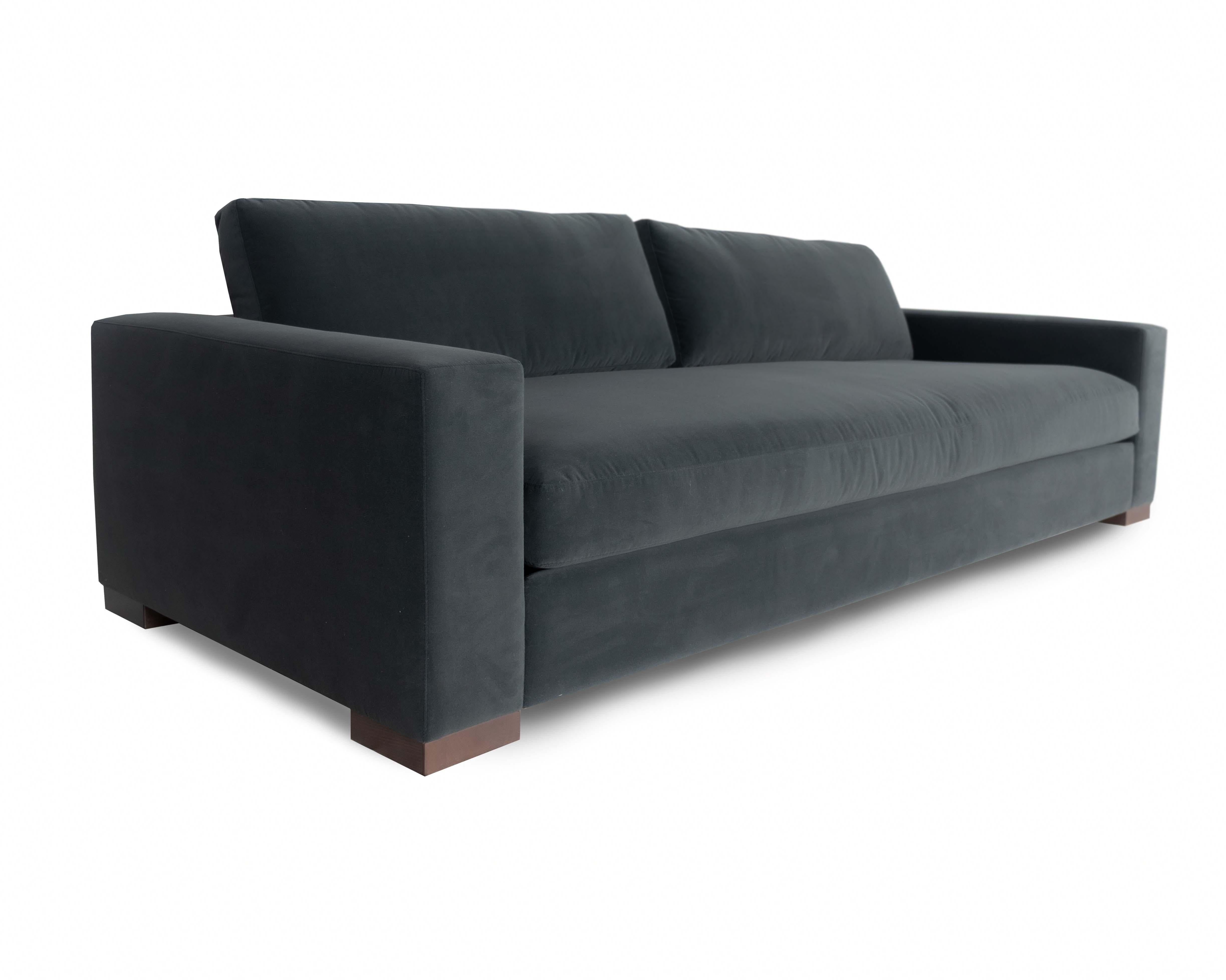 The Terlingua low leg sofa and sectional take inspiration and motifs from the west Texas town it is named after; with a modernist sculpted track arm, comfort is defined with a lux cushion construction. The sofa has a deep and low profile that lies