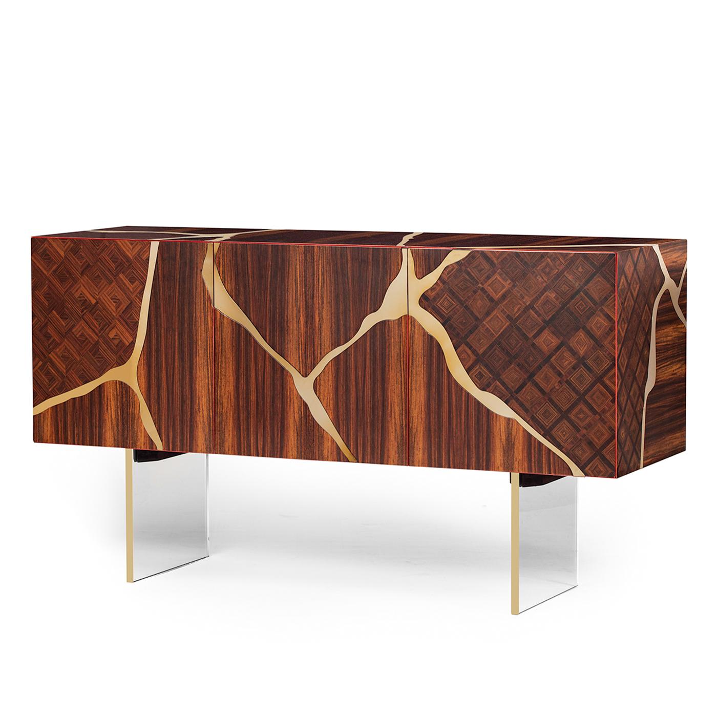 Inspired by the ancient Japanese technique known as Kintsugi, this gorgeous sideboard is a flawless bridge between tradition and innovation. Symbolic of the harmonious blend of past and present, it is handcrafted of veneered and carved rosewood,