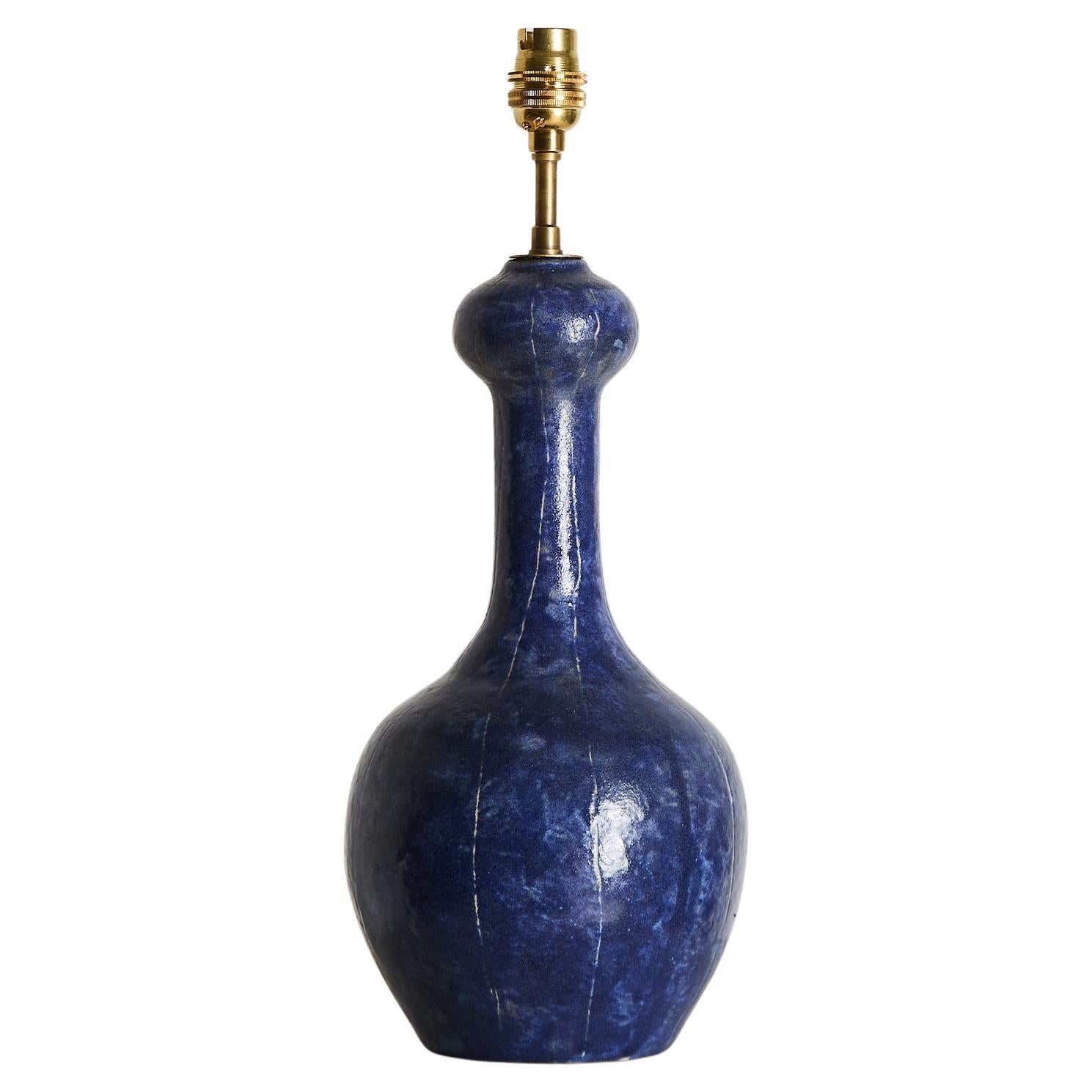 Poetic ceramic table lamp with exaggerated neck and naive markings over the cobalt blue glazed surface.

Unsigned but obviously a skilled hand.

France 1950s

H 55cm x D 20cm (with shade)

H 44cm x D 16cm (w/o)