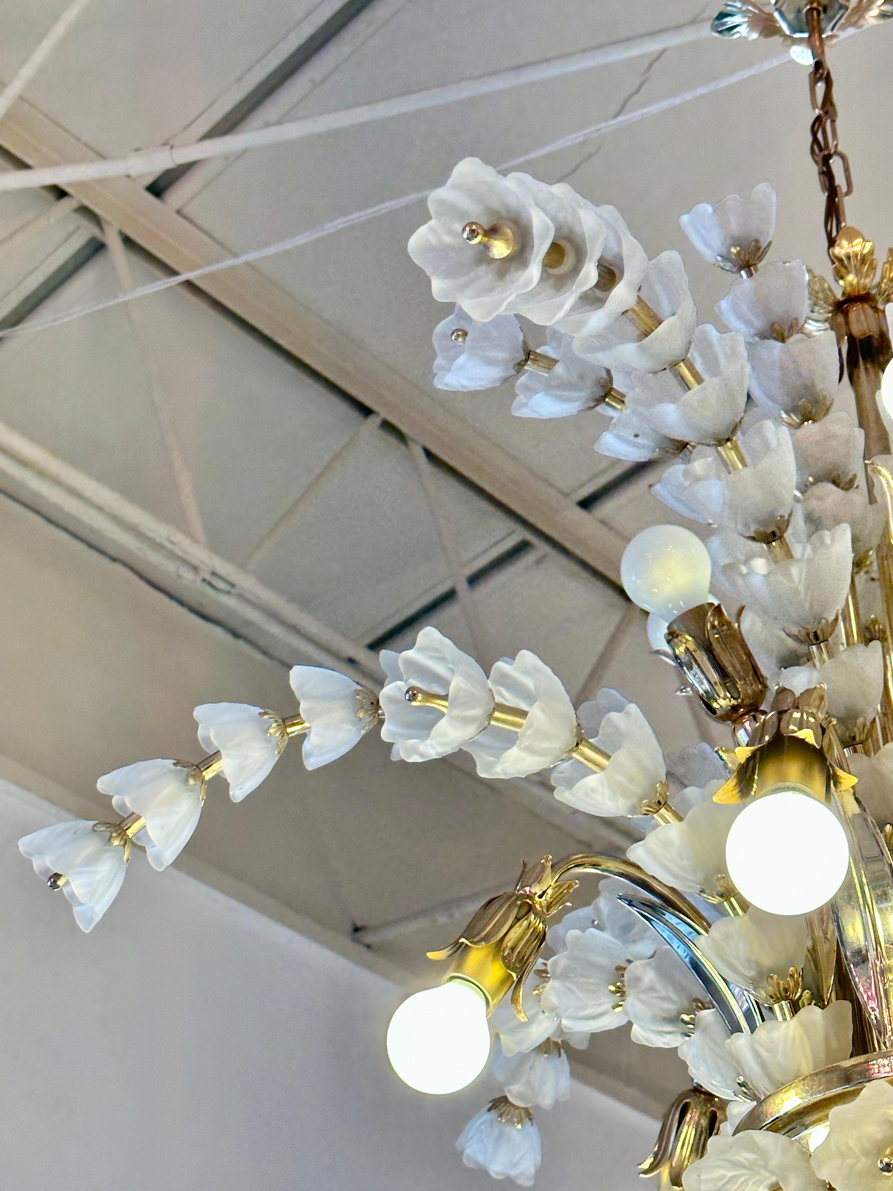 Gold plated metal and white frosted glass bell shaped flower bulbs on all arms.  Petite globe bulbs compliment the look of this chandelier.  Very unique and whimsical.