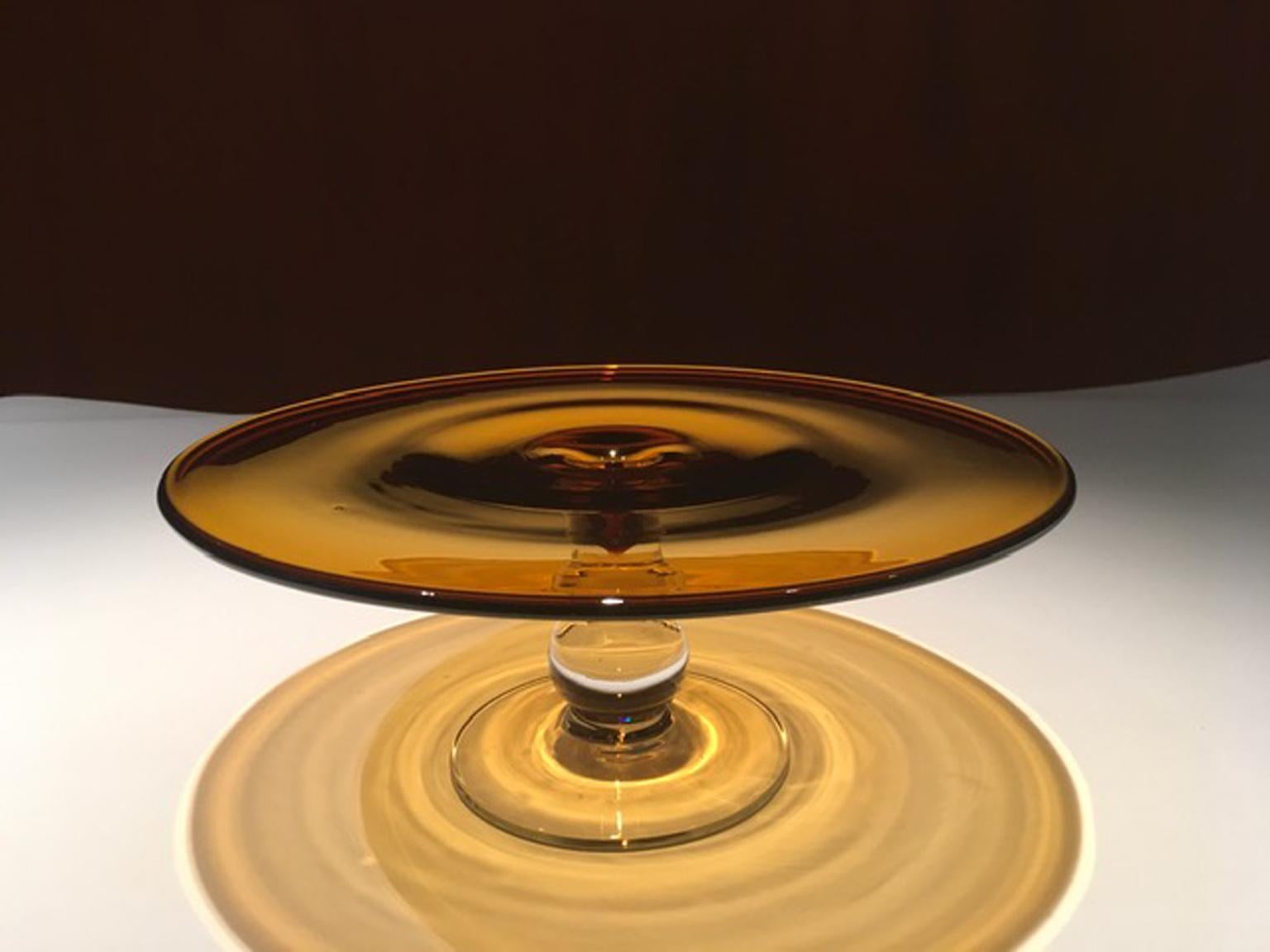Elegant footed dish glass to serve cake or pastries. The amber color is very dense and bright.
Available by us on 1stdibs two gobelets of the same serie.
