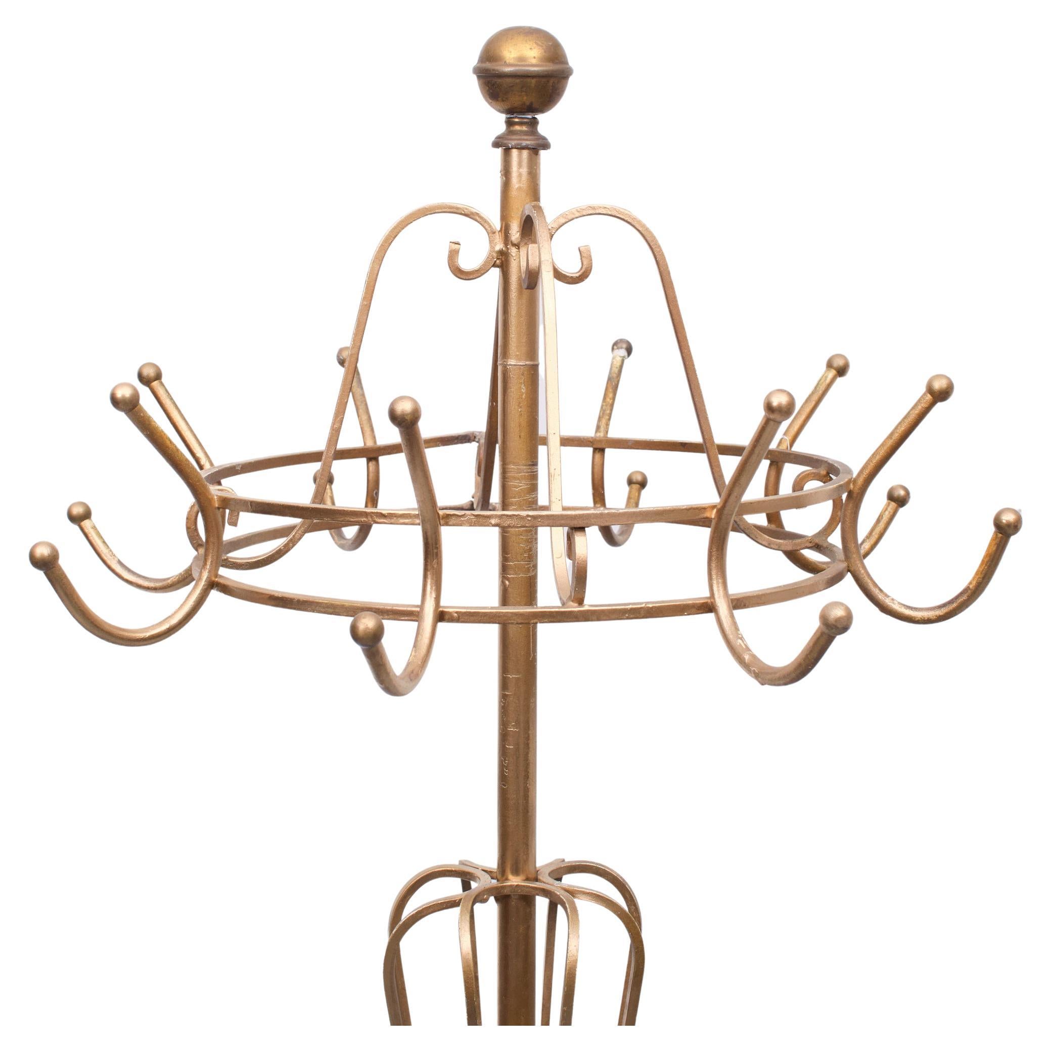 Very nice standing coat rack. Gold color metal. Turntable.
France provincial in style. 1950s.