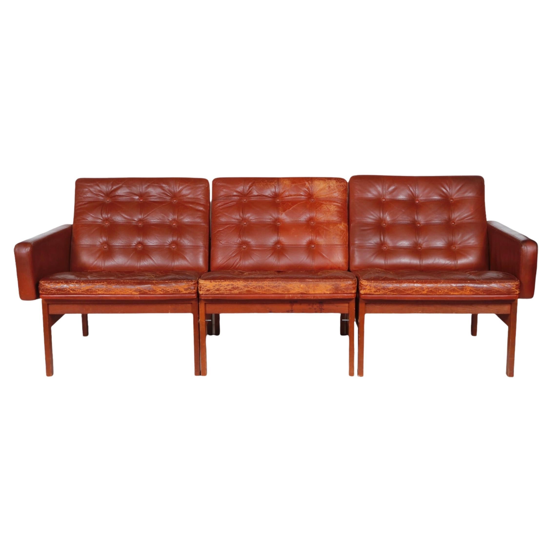 A vintage Moduline collection three-seat sofa designed by Ole Gjerlov-Knudsen & Torben Lind  for France & Son. Denmark, circa 1960.

Signed with France & Son metal tag and marked made in Denmark. 

A period Danish modern sofa in original tufted