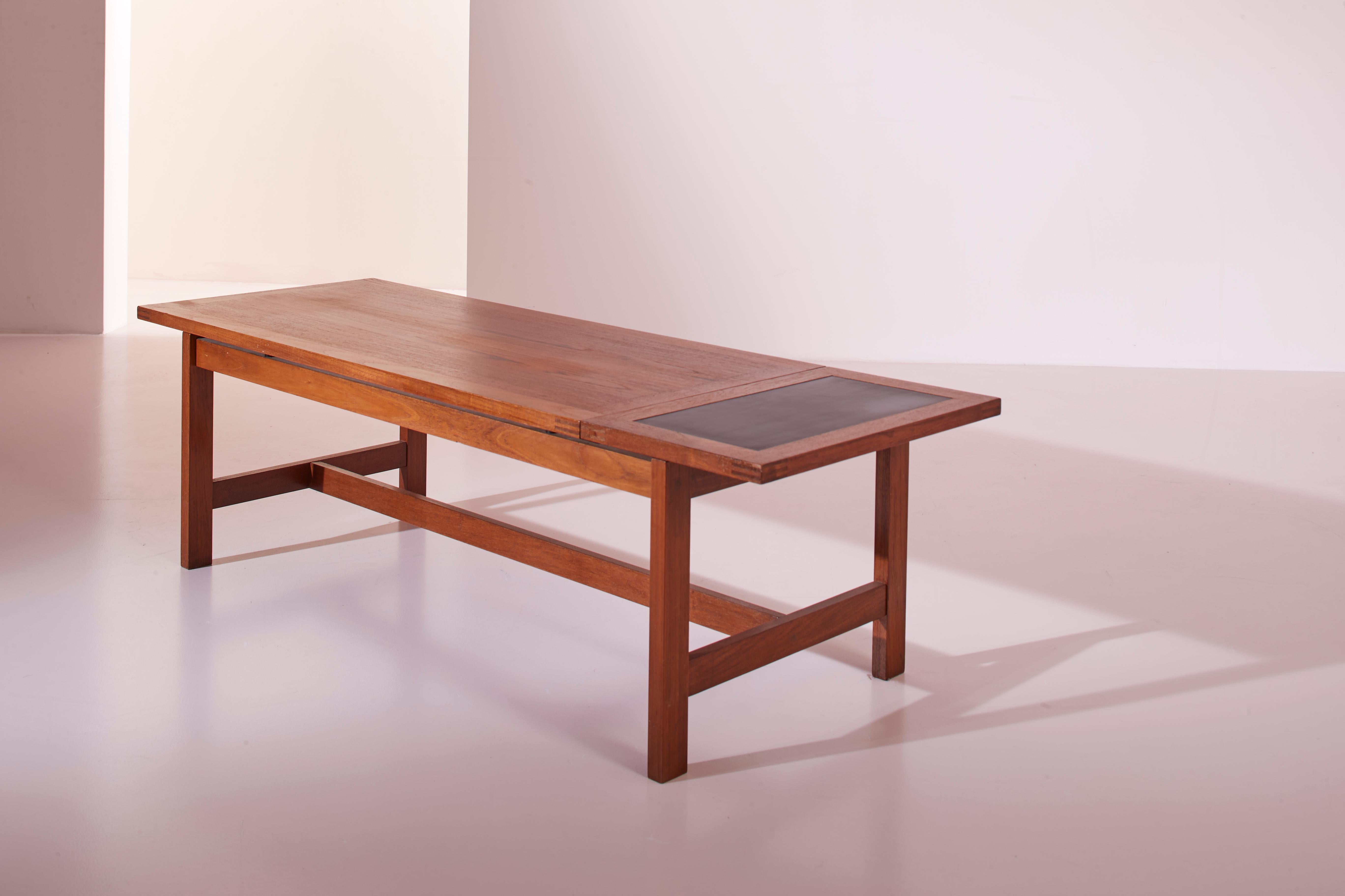 A danish solid teak coffee table, produced by France & Son in the Sixties.

This coffee table stands out for its simple line and a mechanism that allows expanding the surface when needed. The main teak top slides on dedicated rails, allowing the