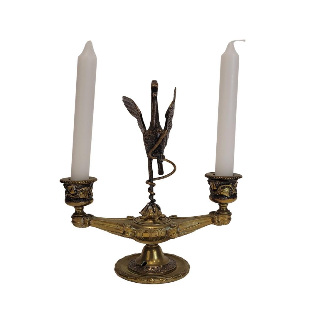 Amazing and very refined  two-light 19th-century candlestick by Frenchman August-Maximilien Delafontaine (1813-1892). In the center, the figure of a heron gracefully holds a serpent in one of its legs, while resting on a turtle with the other. The