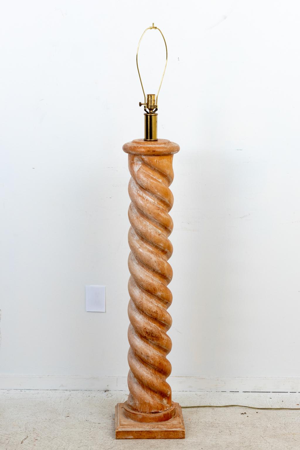 Circa 1970s large scale turned barley twist column floor lamp on square base in the style of Frances Elkins. The piece is composed of bleached wood with beige linen shade and brass socket collar. Marked 