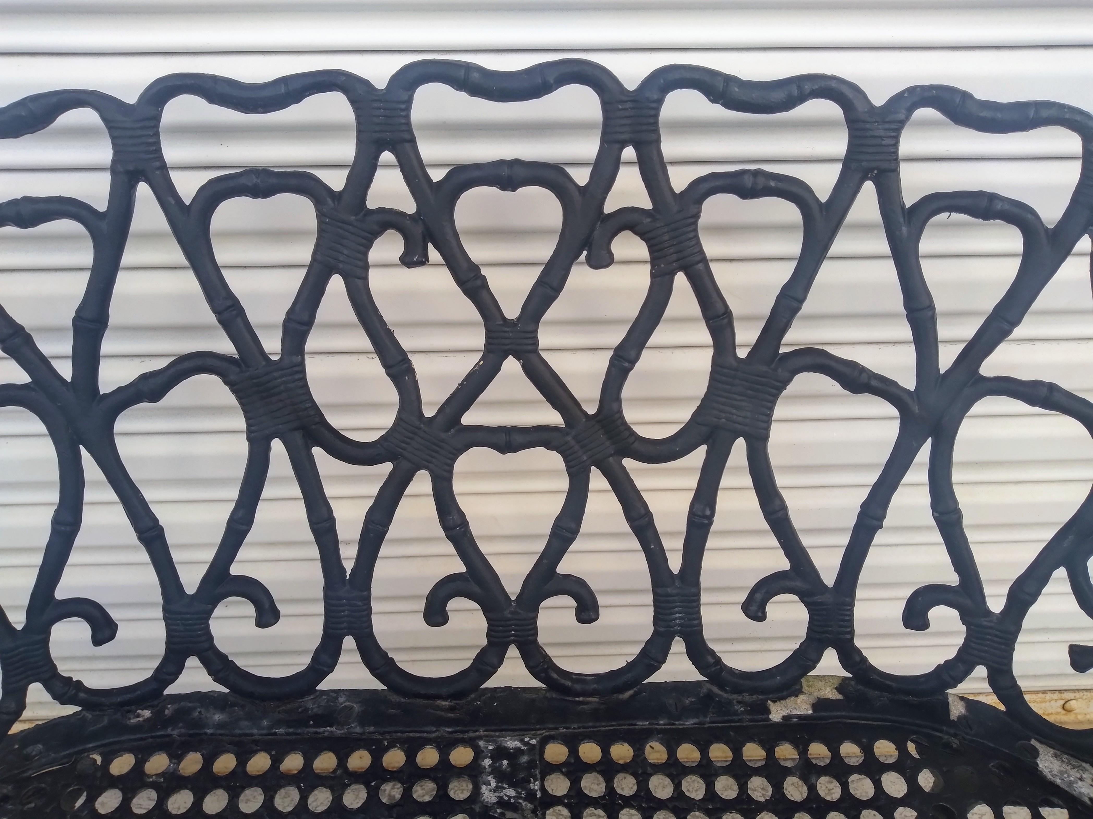 A pair of cast aluminum benches made in the style of Frances Elkins. The benches are sturdy and have X-base stretchers for stability. The legs and stretches have a faux bamboo look.