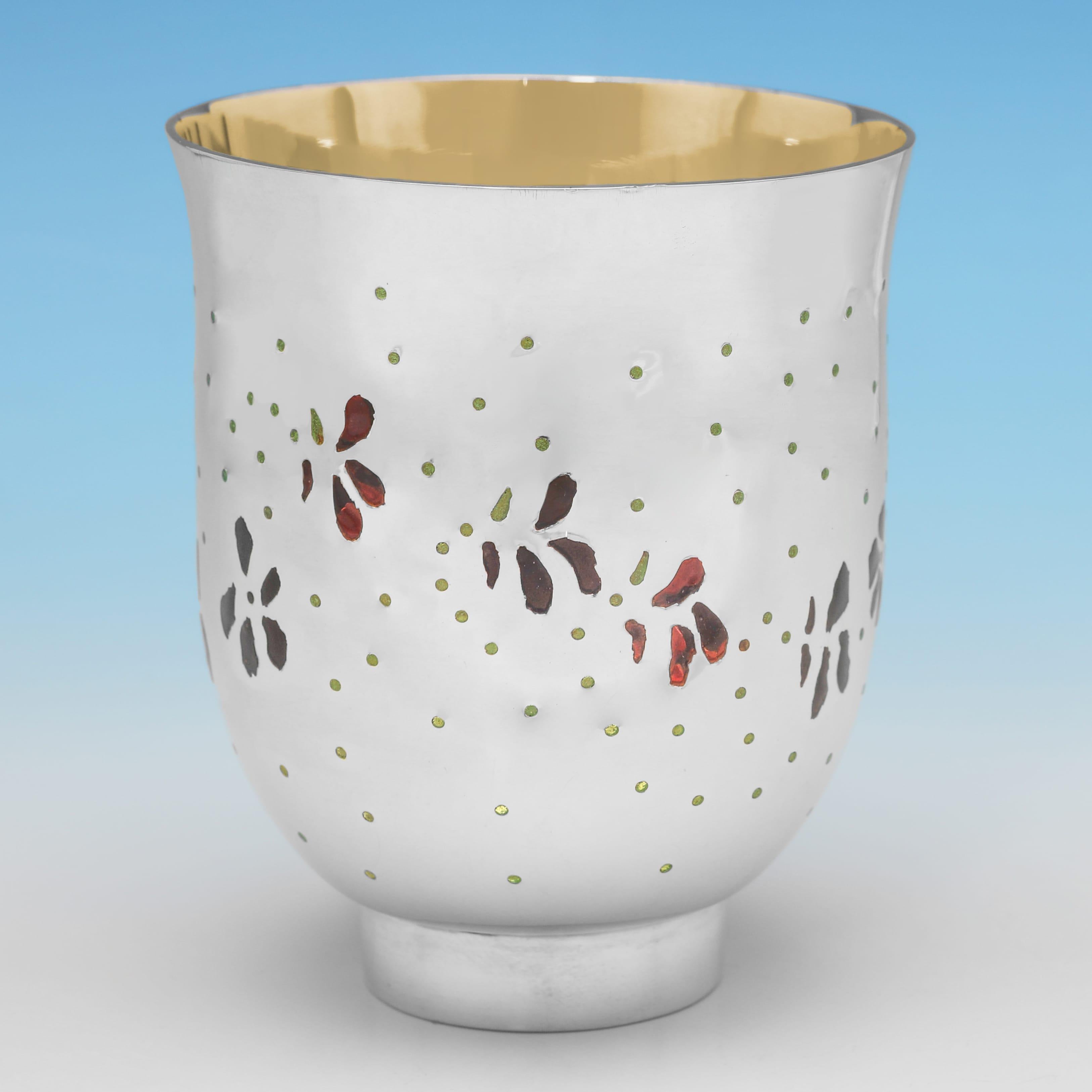 Hallmarked in London in 1987 by Frances Loyen, this attractive, Elizabeth II period, Sterling Silver Beaker, features Plique-a-Jour enamel decoration which fades from red to green in colour, and a gilt interior. The beaker measures 3