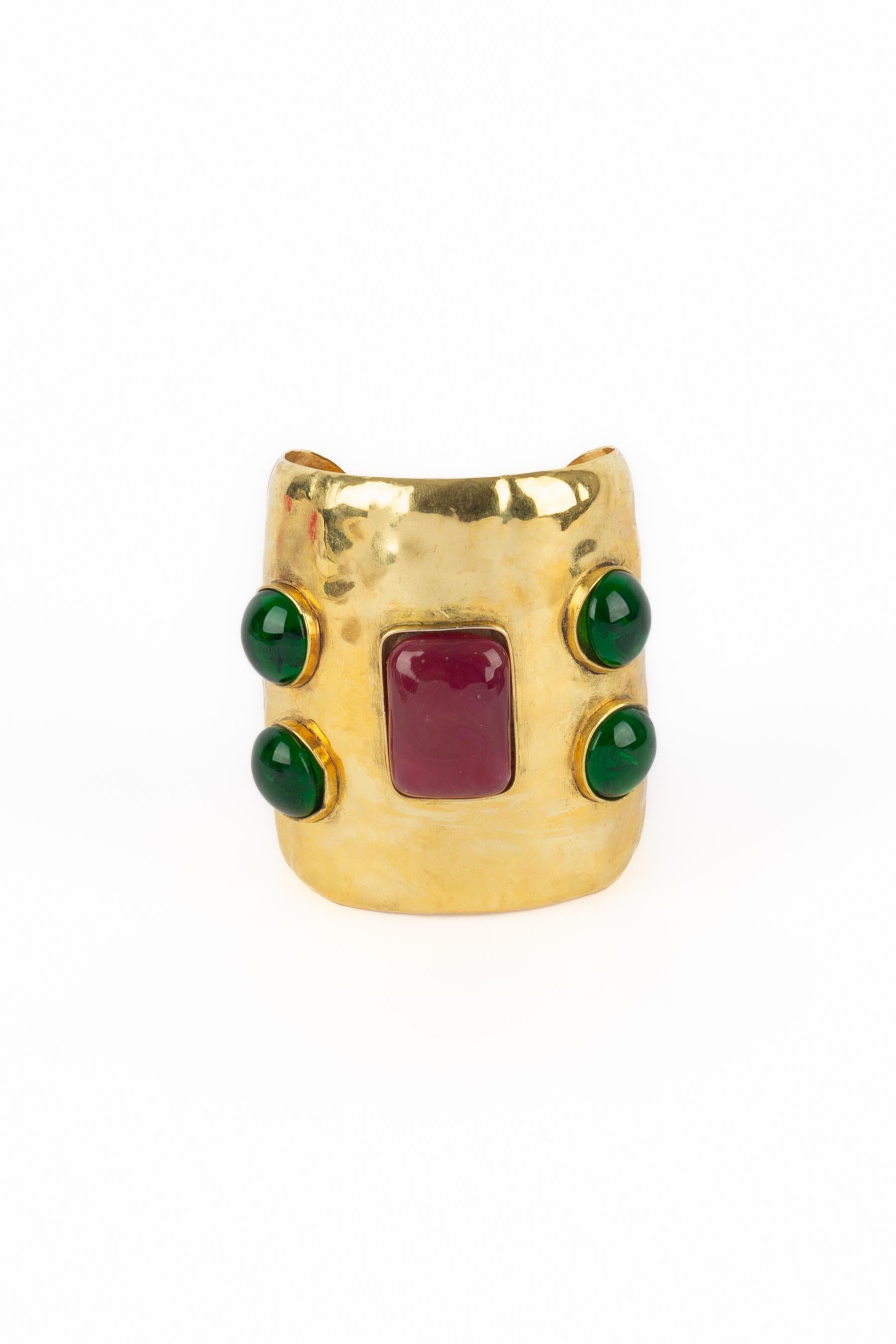 FRANCES PATIKY STEIN - Beaten golden metal cuff bracelet topped with glass paste cabochons.

Condition:
Very good condition

Dimensions:
Height: 7.5 cm - Wrist circumference: 15 cm - Opening: 2.7 cm

SKU:BRA46