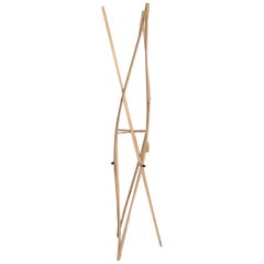 Francesca is a Freestanding Wooden Coat Rack, Characterized by Tension and Light