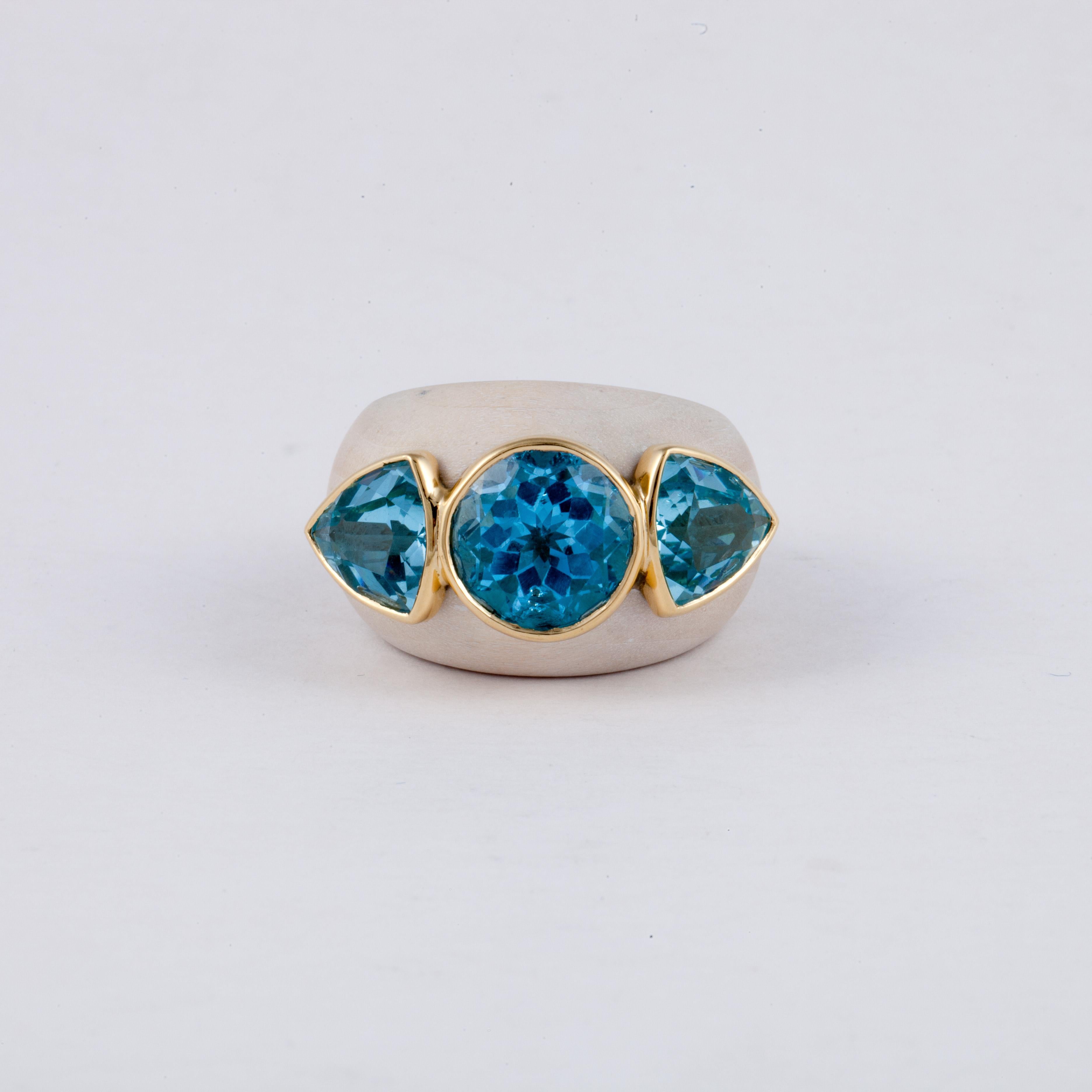 Francesca Visconti ring composed of wood with yellow gold lining on the inside.  The ring features three blue topaz stones that are bezel set in yellow gold.  It measures 1 1/4 inches by 3/4 inches.  