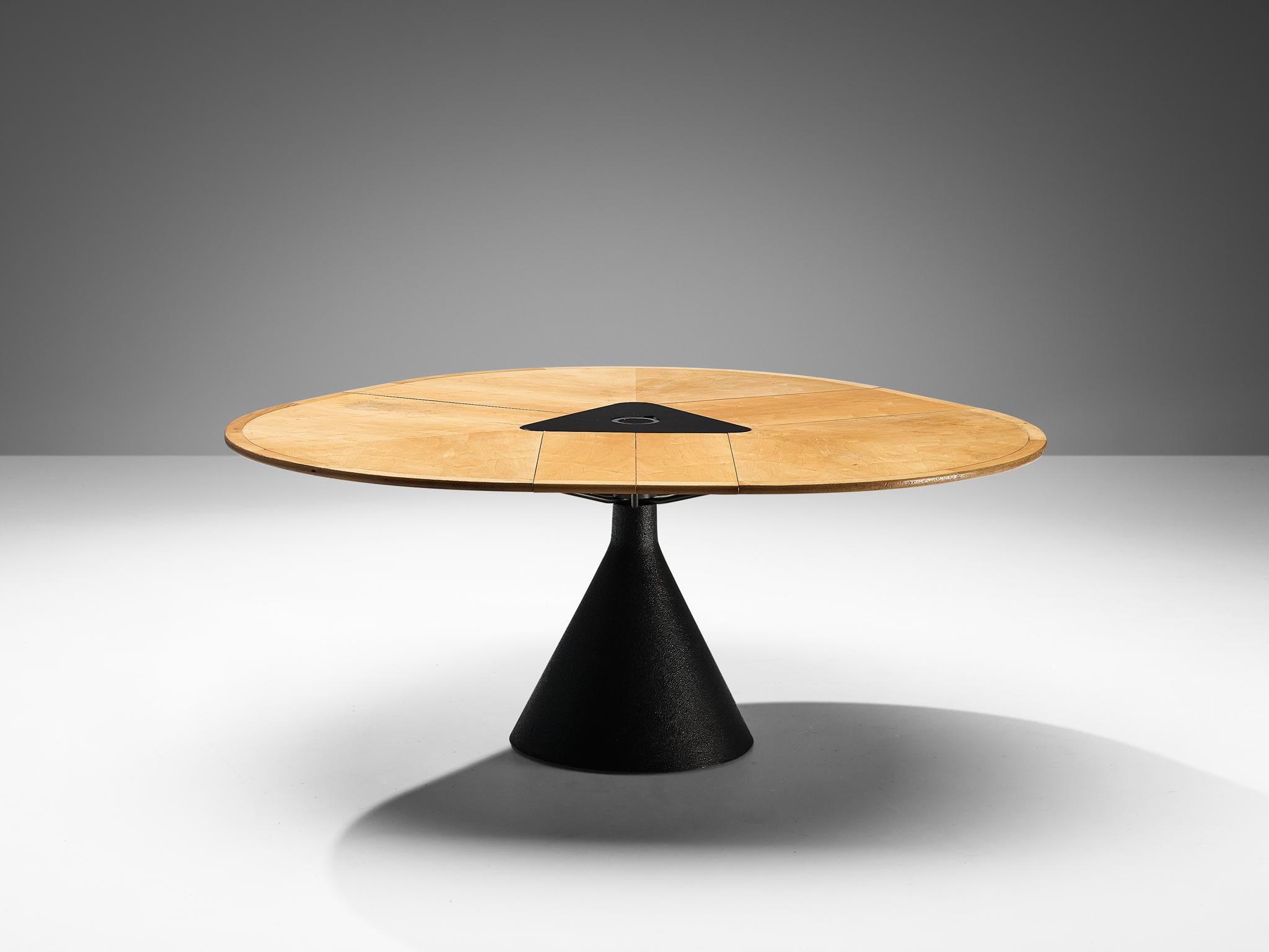 Francesco Fois for Bernini, 'Click' dining table maple, metal, Italy, 1986
 
The table model Click, conceived by Francesco Fois for Bernini in the year 1986, stands as a testament to functional elegance. Its foundation is a cone-shaped metal base,