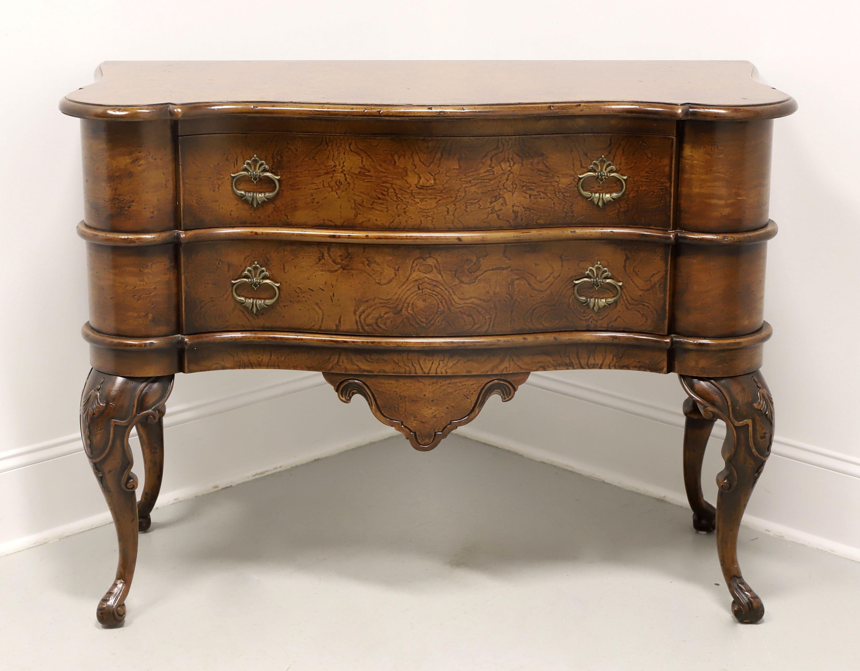 An Italian style commode chest by Francesco Molon for Giemme. Burl walnut with serpentine shape, bevel edge to the top, brass hardware, decoratively carved apron, carved knees, cabriole legs, and paw feet. Features two large drawers. Made in Romano