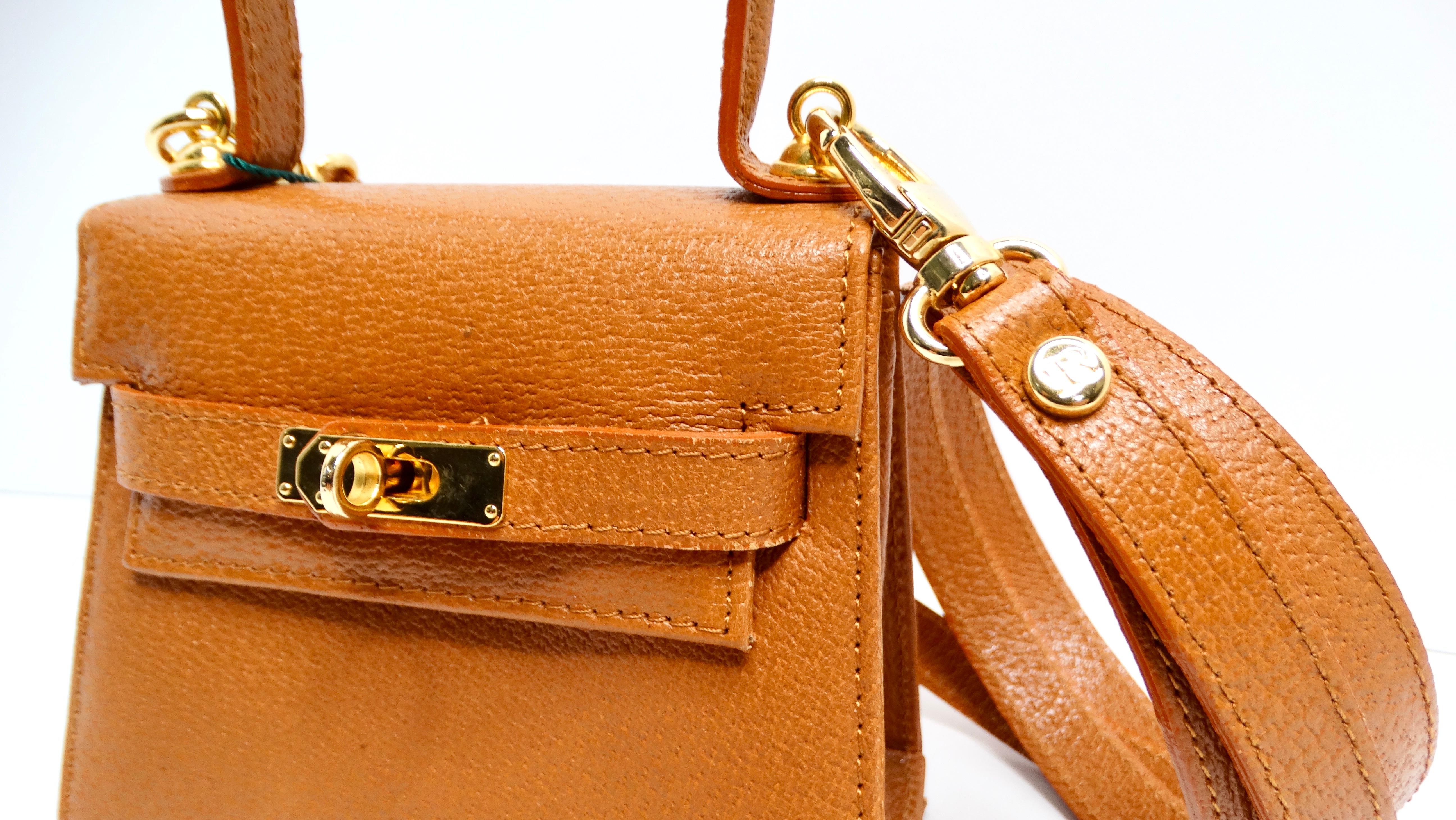 Introducing the Francesco Rogani Mini Leather Top Handle Crossbody Bag, a chic accessory crafted in Italy that epitomizes sophistication and versatility. With its rich warm brown hue, this bag beautifully complements a variety of ensembles, making