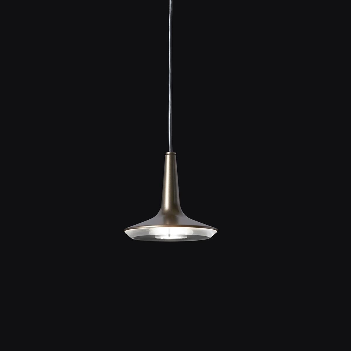 Suspension Lamp 'Kin' 478 designed by Francesco Rota in 2013.
Suspension lamp giving direct and diffused light. Metal turned body lamp. PMMA transparent diffuser. Manufactured by Oluce, Italy.

A cast aluminium body with a Led core are the