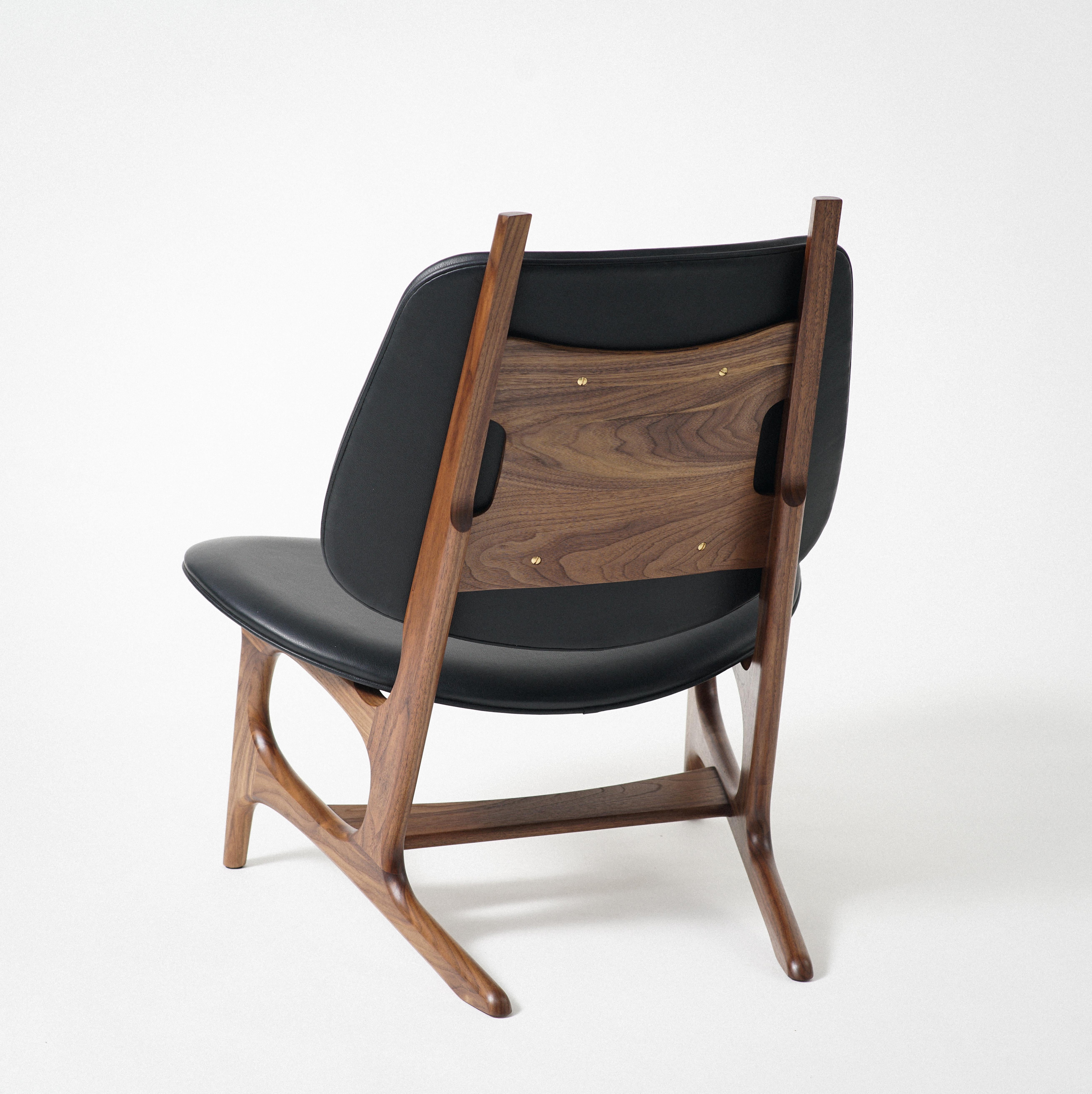 Phloem Studio Francis easy chair is a modern contemporary oversized easy chair with a exposed solid walnut hardwood frame with an upholstered shell seat and back, with wool upholstery. Francis is a roomy easy chair for drinking Americanos or wine,