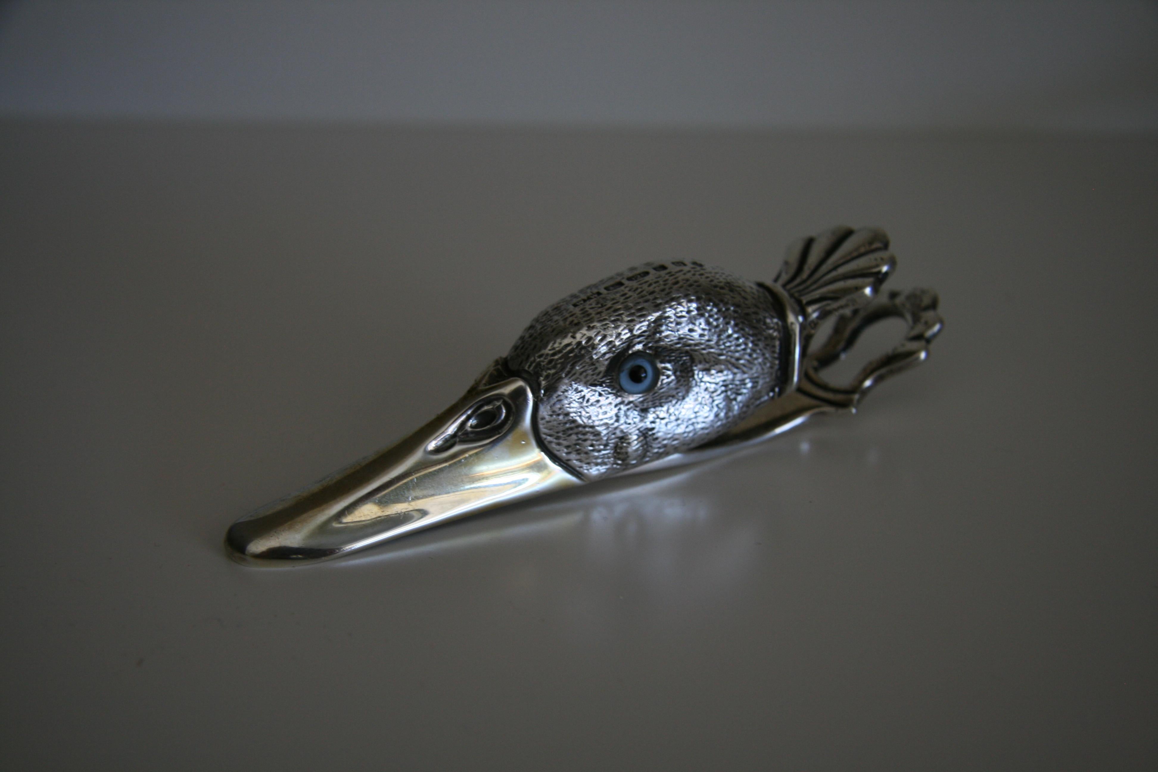 Francis Howard Hallmarked sterling silver novelty duck head paper clip.

English hallmarked solid silver ducks head. Features hinged sprung beak to clip together loose paperwork. Silver gilt beak with realistic life-like glass eyes.