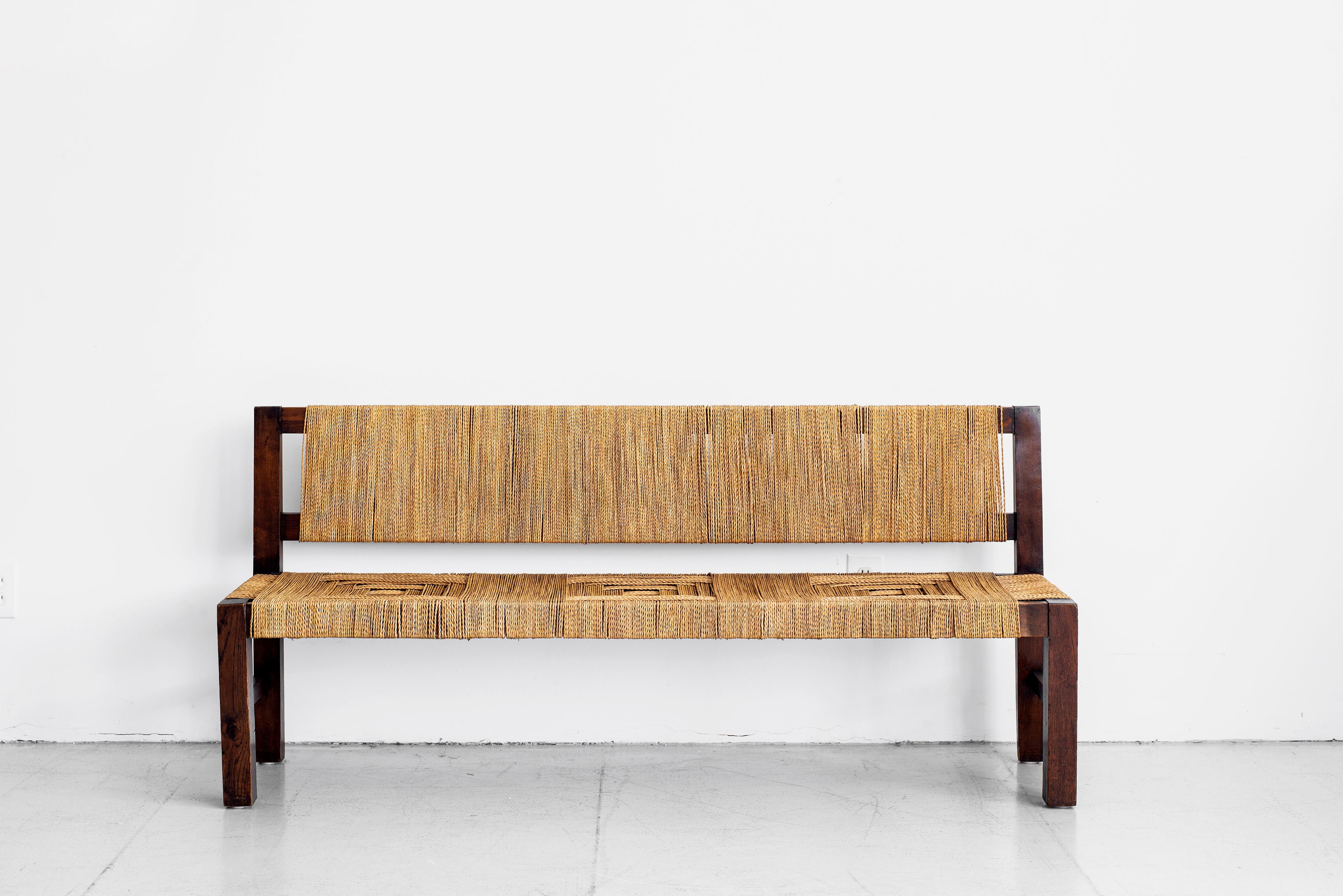 Stunning bench by Francis Jourdain with patterned braided rushed seat and blackened beechwood frame. Eye-catching piece.