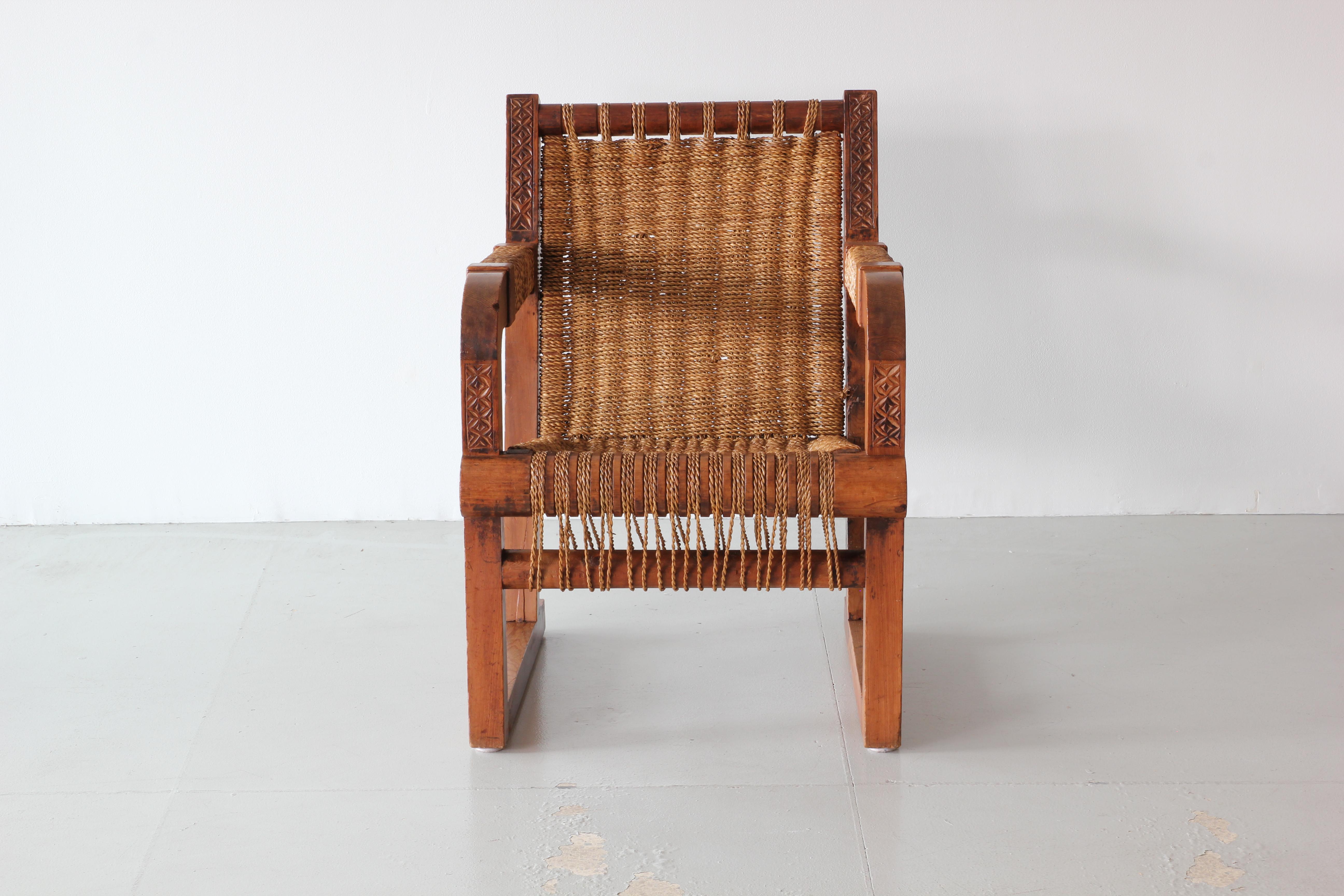 Wonderful woven chair by Francis Jourdain with woven seat and back, intricate carvings detailing throughout and oak frame.
