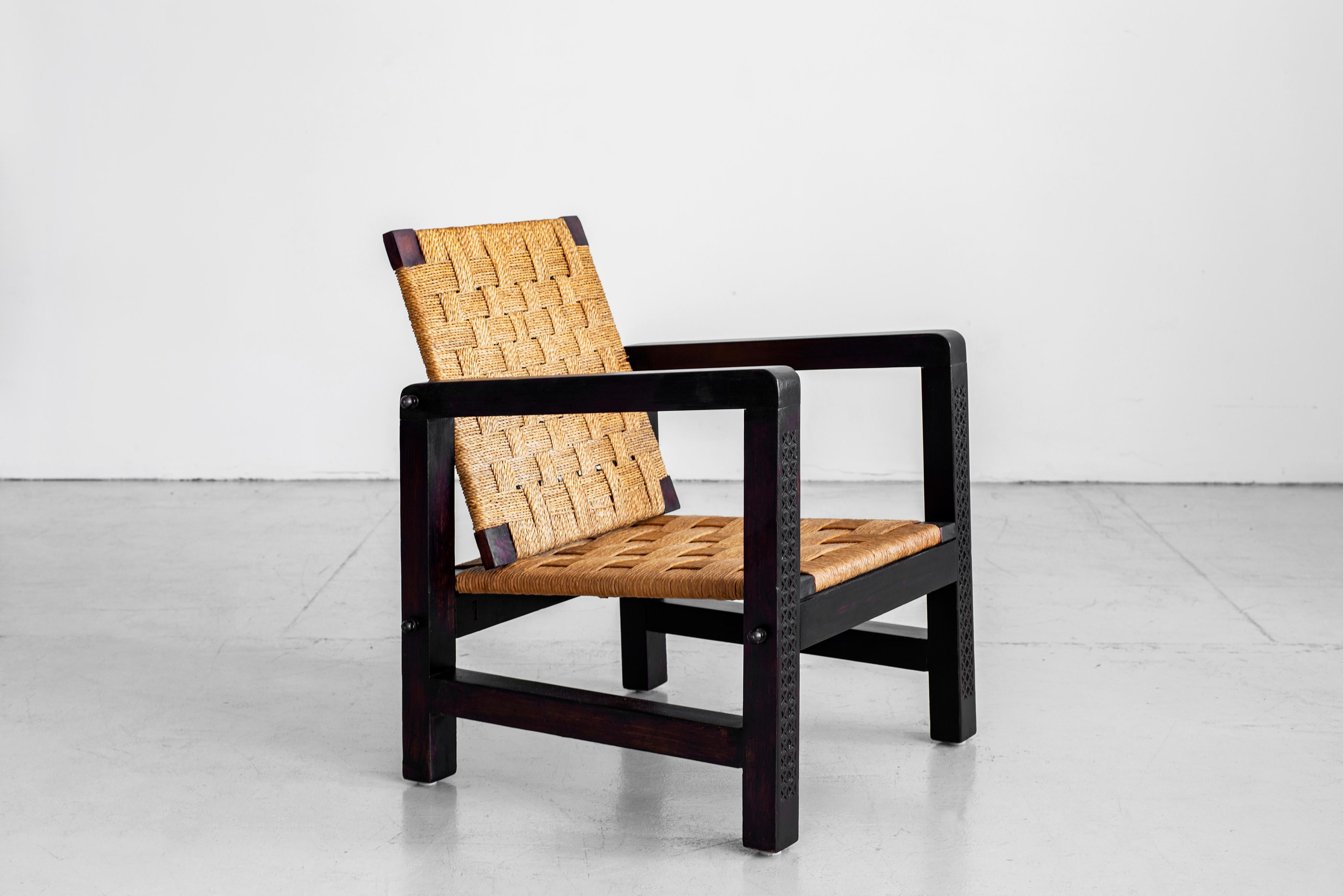 Pair of Francis Jourdain chairs with beautiful hand carved detailing on wood frame and woven straw seats. Solid frames with adjustable tilt woven rope backs make these incredible and unique. Great from every angle with wonderful patina.
 