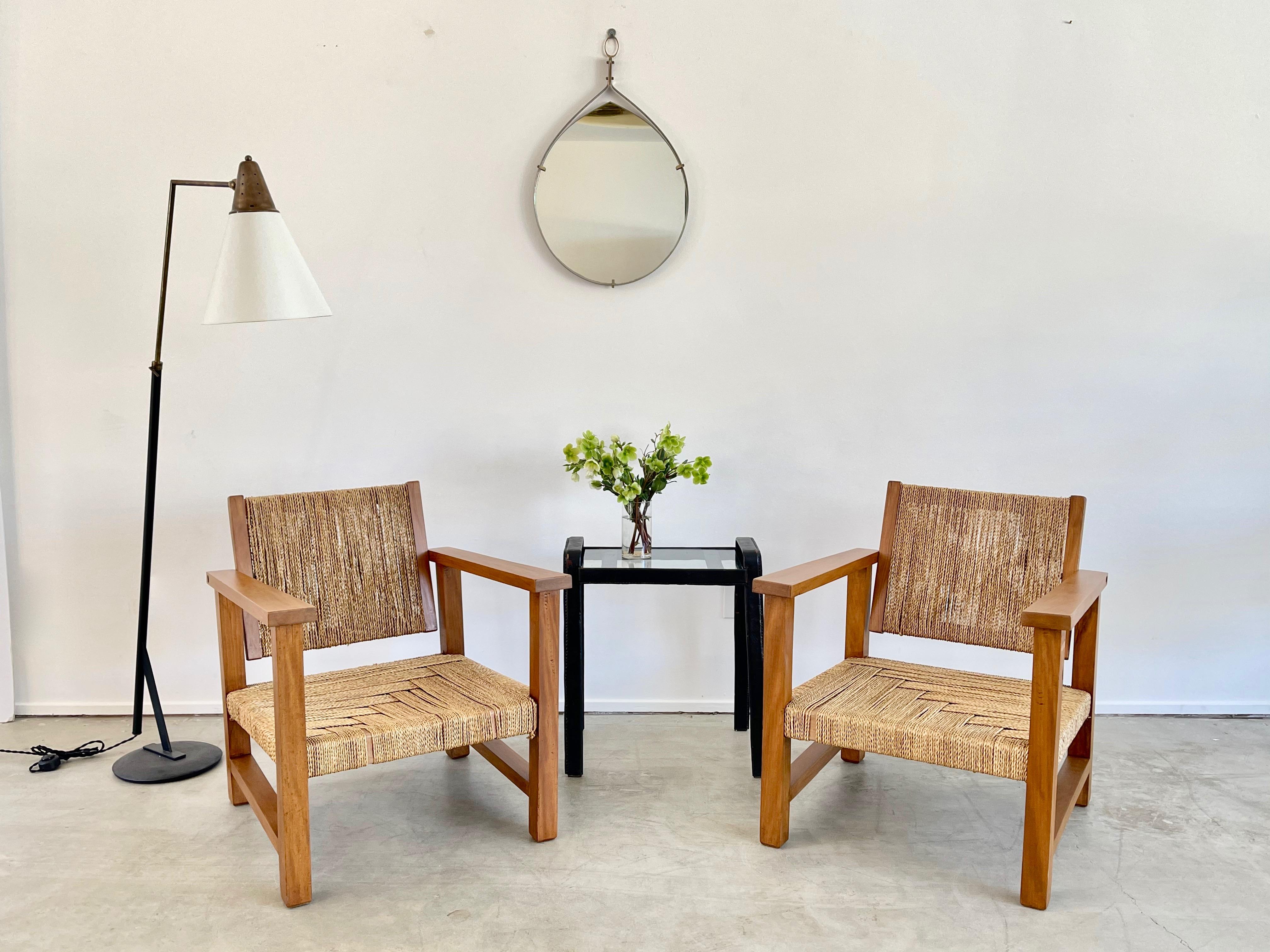 Classic wood and rope armchairs by French designer, Francis Jourdain, circa 1930. 
Beautiful patina to wood and exceptional woven design.
Newly woven seats and newly refinished.