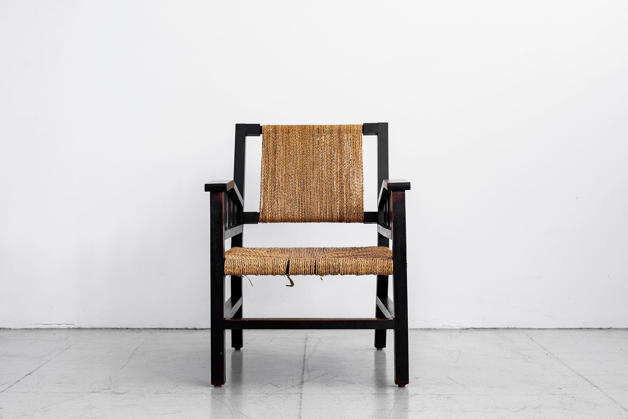 Classic wood and rope armchair by French designer, Francis Jourdain, circa 1930. Beautiful patina to wood and exceptional woven design.