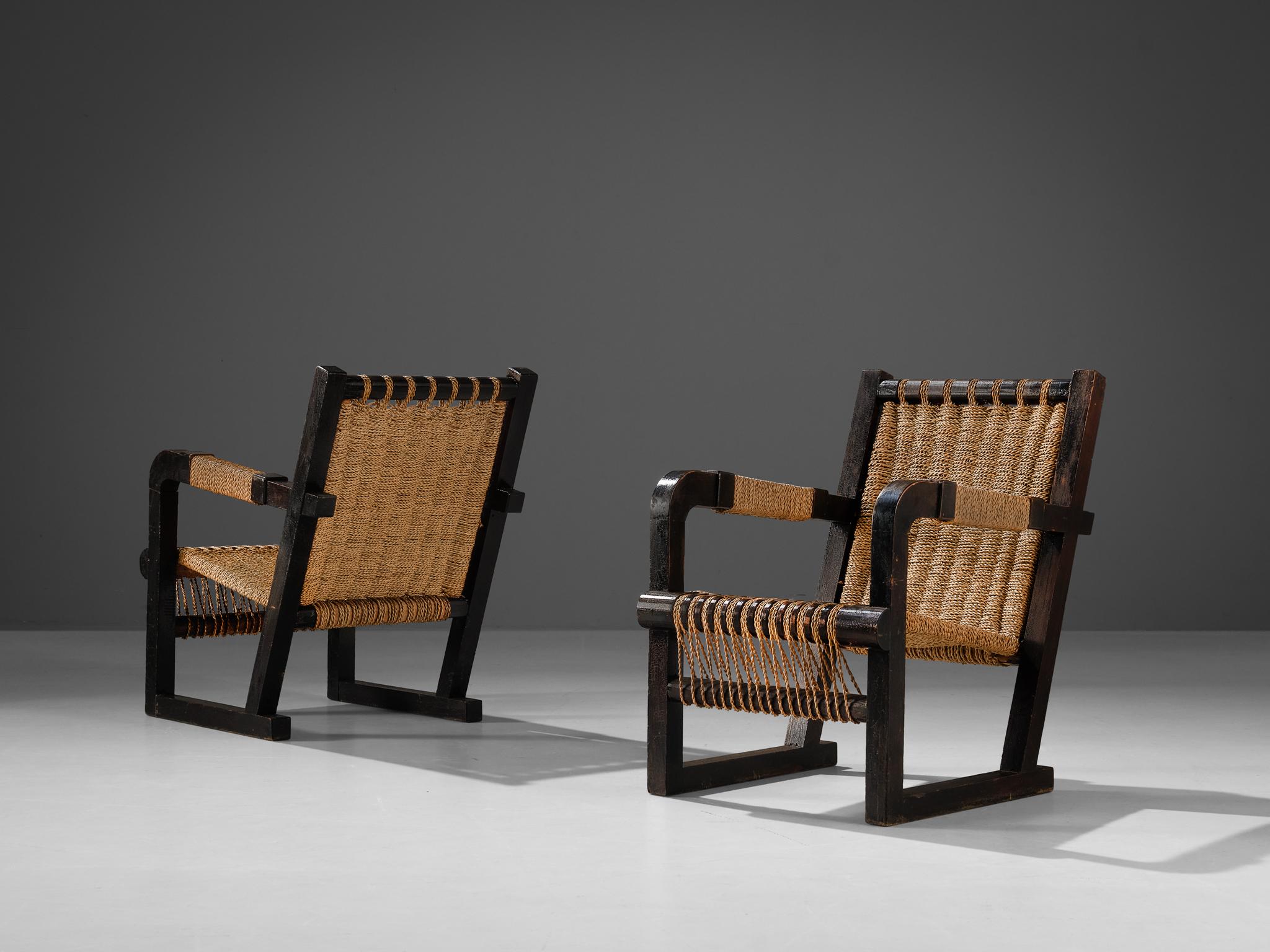 Francis Jourdain, pair of lounge chairs, dark stained pine, rope, France, 1930s

This stunning pair of lounge chairs was designed by Francis Jourdain in France around 1930. The chair show a raked back and the seat is created out of intertwined