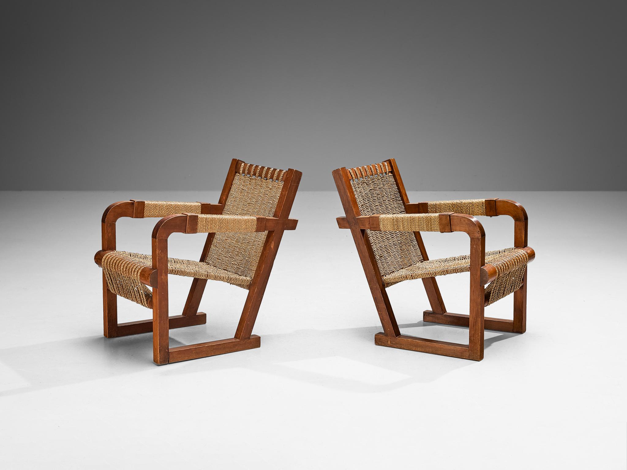 Francis Jourdain, pair of lounge chairs, dark stained pine, straw, France, 1930s

Crafted around 1930 in France, these exquisite armchairs were designed by Francis Jourdain. The chairs feature a gracefully inclined back, and the seat is skillfully