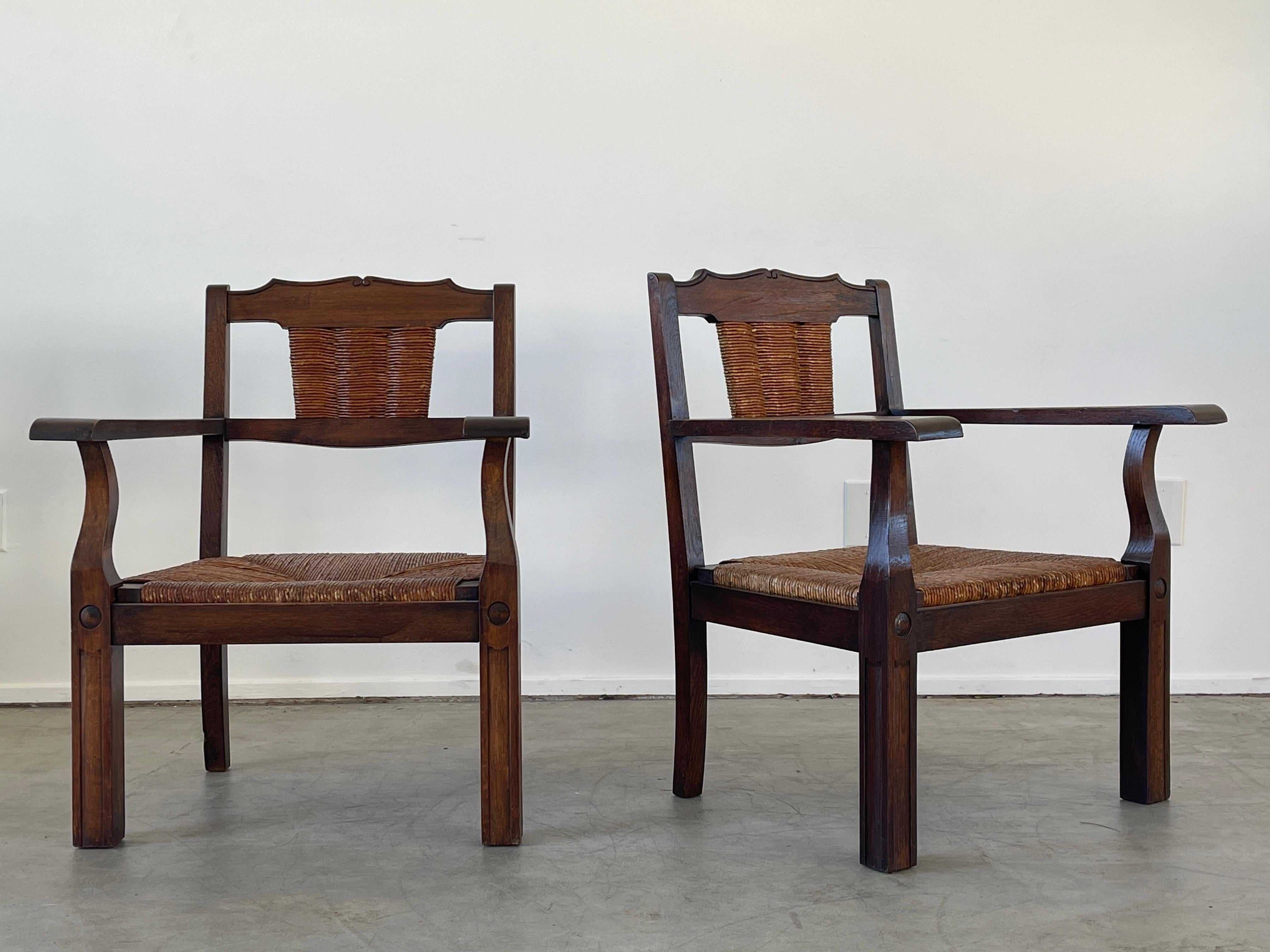Pair of 1950's French oak and rush chairs in the style of Francis Jourdain with woven seats and backs, curved lines.