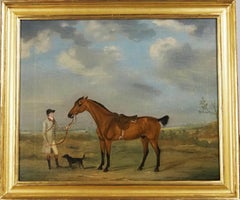 A horse and groom with a dog