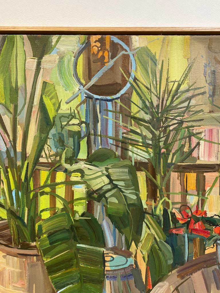 This painting of plants on a porch is from Francis Sills' 2017 series of Flora Paintings. Verdant leafy palms in planters stand behind a wooden table with bright red potted flowers and another lush, leafy green plant in this outdoor scene. Framed in