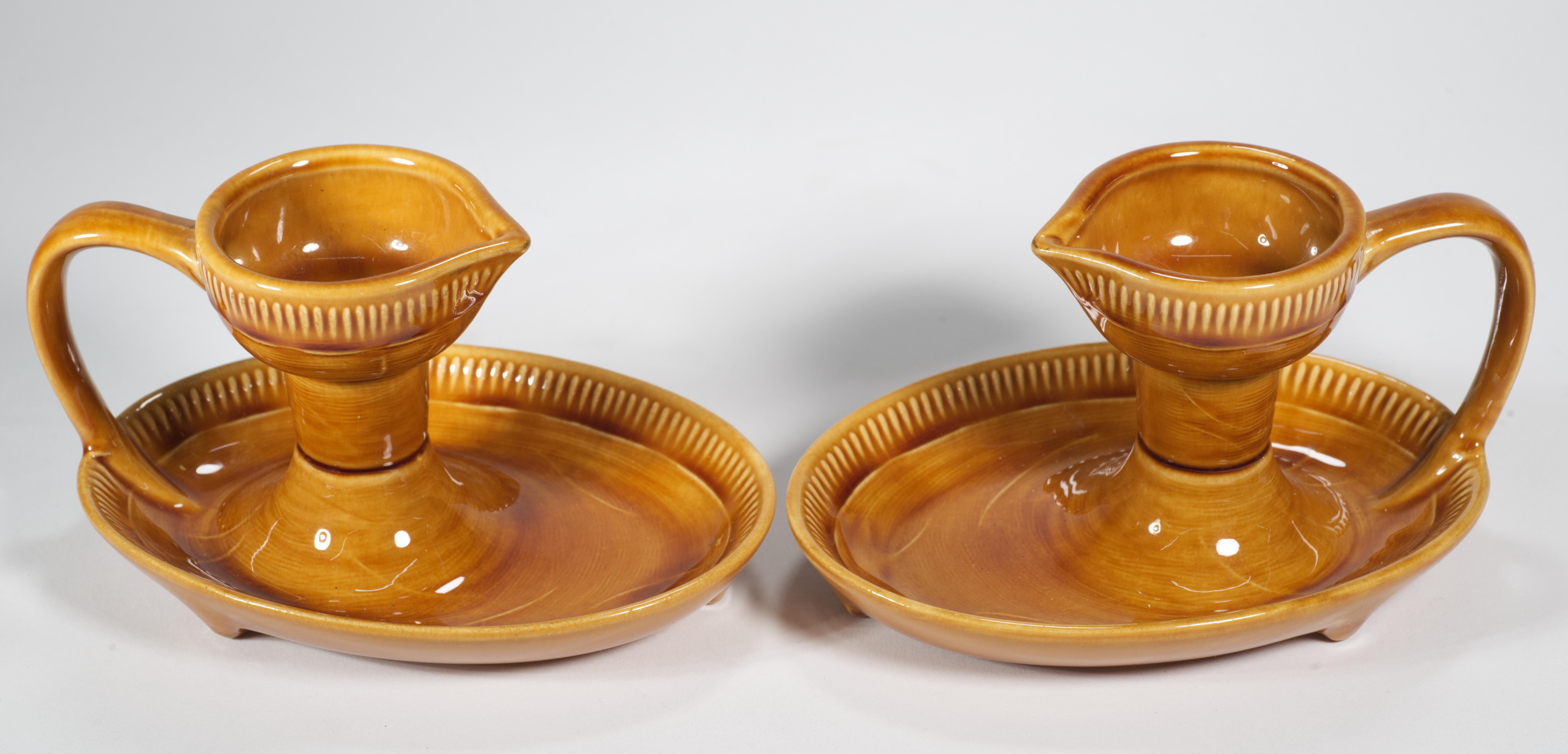  Rare pair of taper candle holders feature classic Mid Century Modern lines with combination of lightly textured ceramic surfaces and high gloss glaze providing additional visual interest to the monochromatic pieces. Both bobeche and the tray are