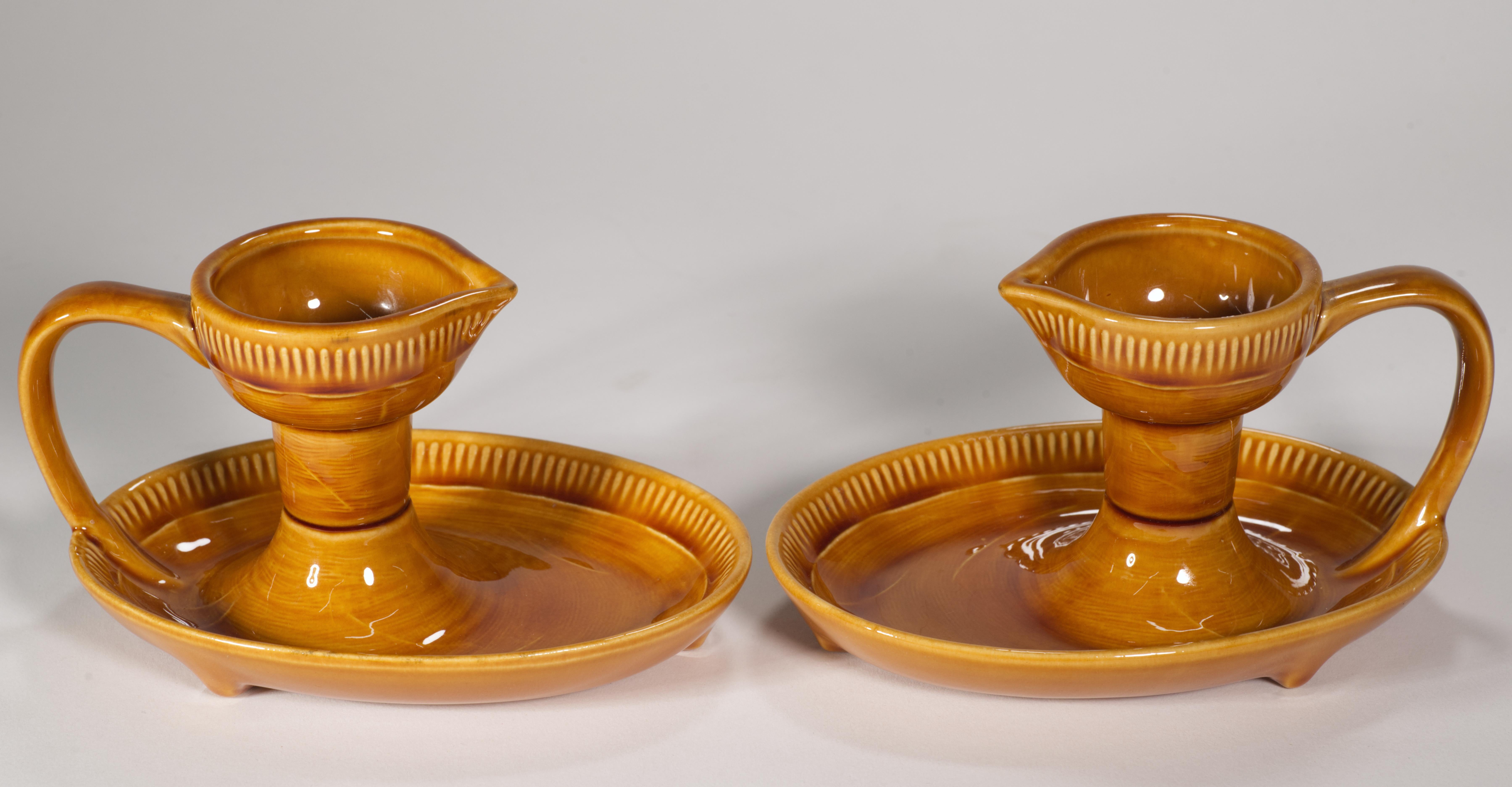  Rare pair of taper candle holders feature classic Mid Century Modern lines with combination of lightly textured ceramic surfaces and high gloss glaze providing additional visual interest to the monochromatic pieces. Both bobeche and the tray are