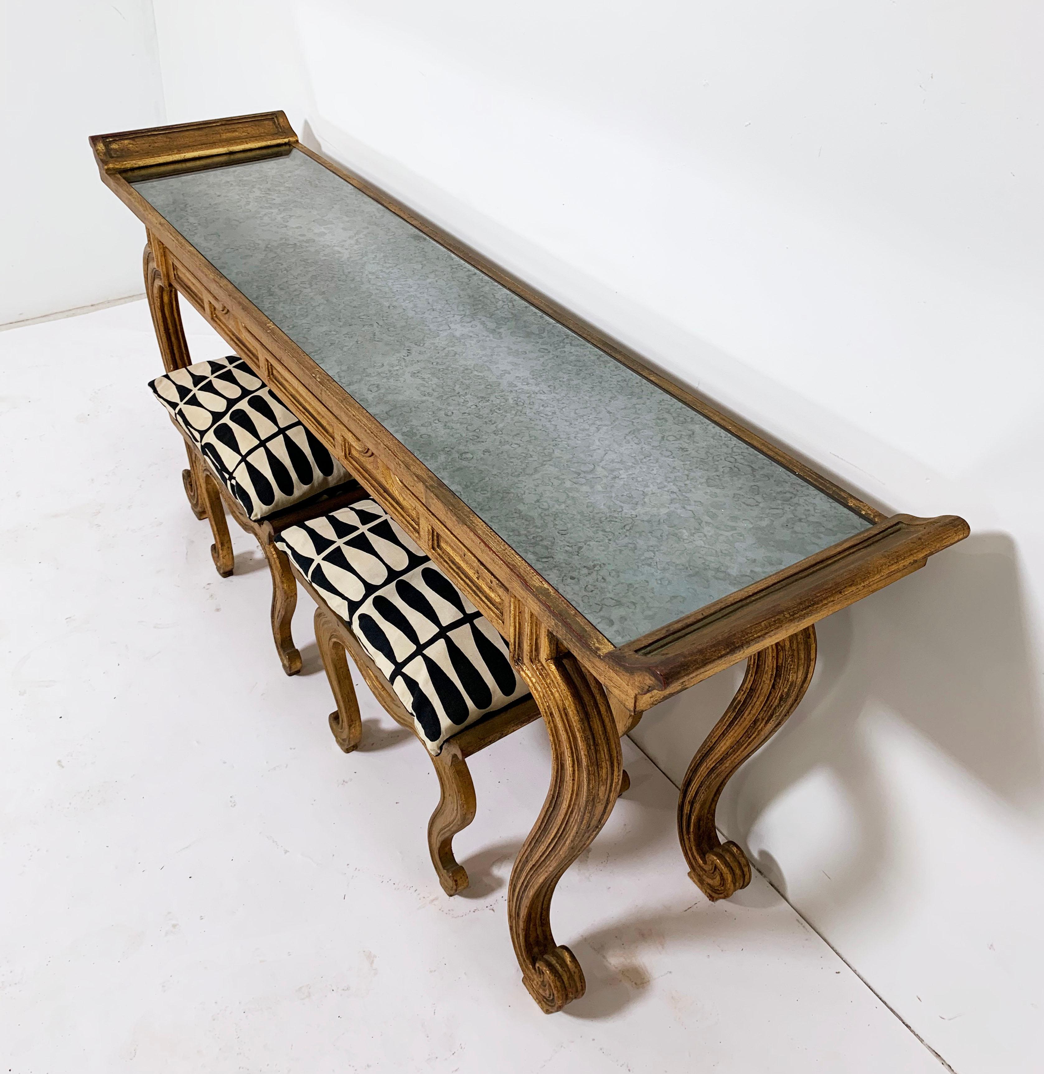 1950s carved wood and gold painted console with veined mirrored top and bench seats, made in Spain by architect Francisco Hurtado. The console measures: 65