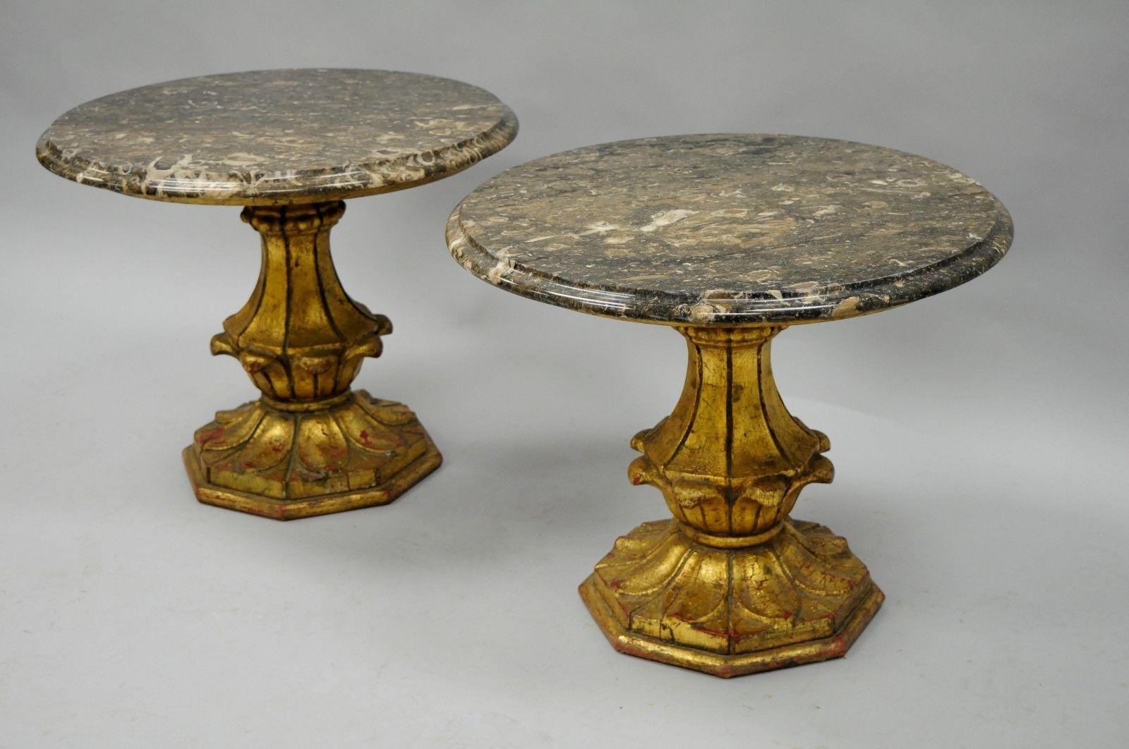 Pair of gold giltwood Hollywood Regency Italian style marble-top low tables by Francisco Hurtado. Item details solid wood pedestal bases, nicely carved details, distressed gold finish, original Francisco Hurtado label, and round marble tops, circa