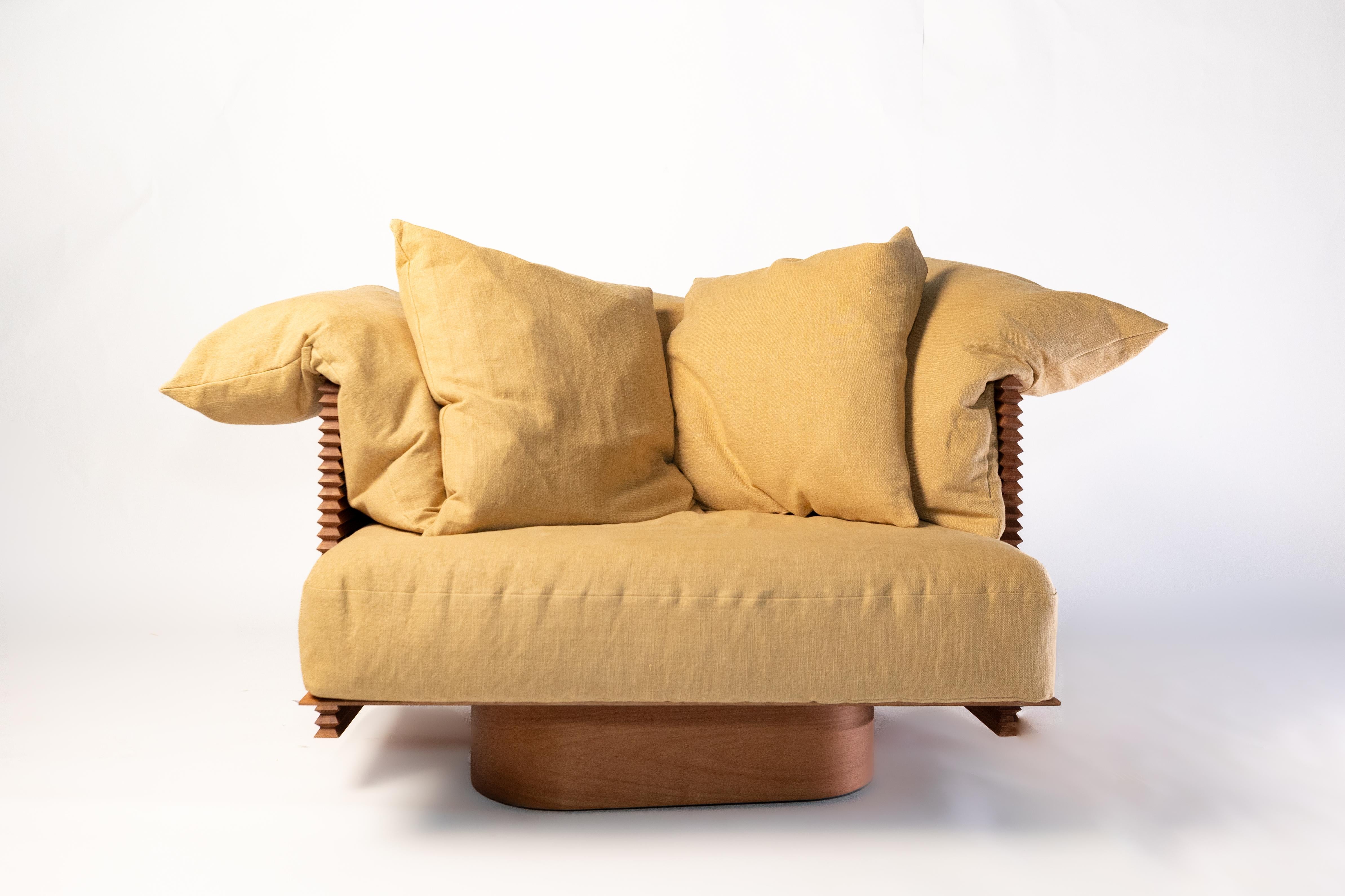 This armchair from the Francisco collection—designed by Bruno de Carvalho as a tribute to his youngest son—translates the warmth and expressive craftsmanship of the original sofa into a more compact, sculptural form. Made entirely from solid wood,