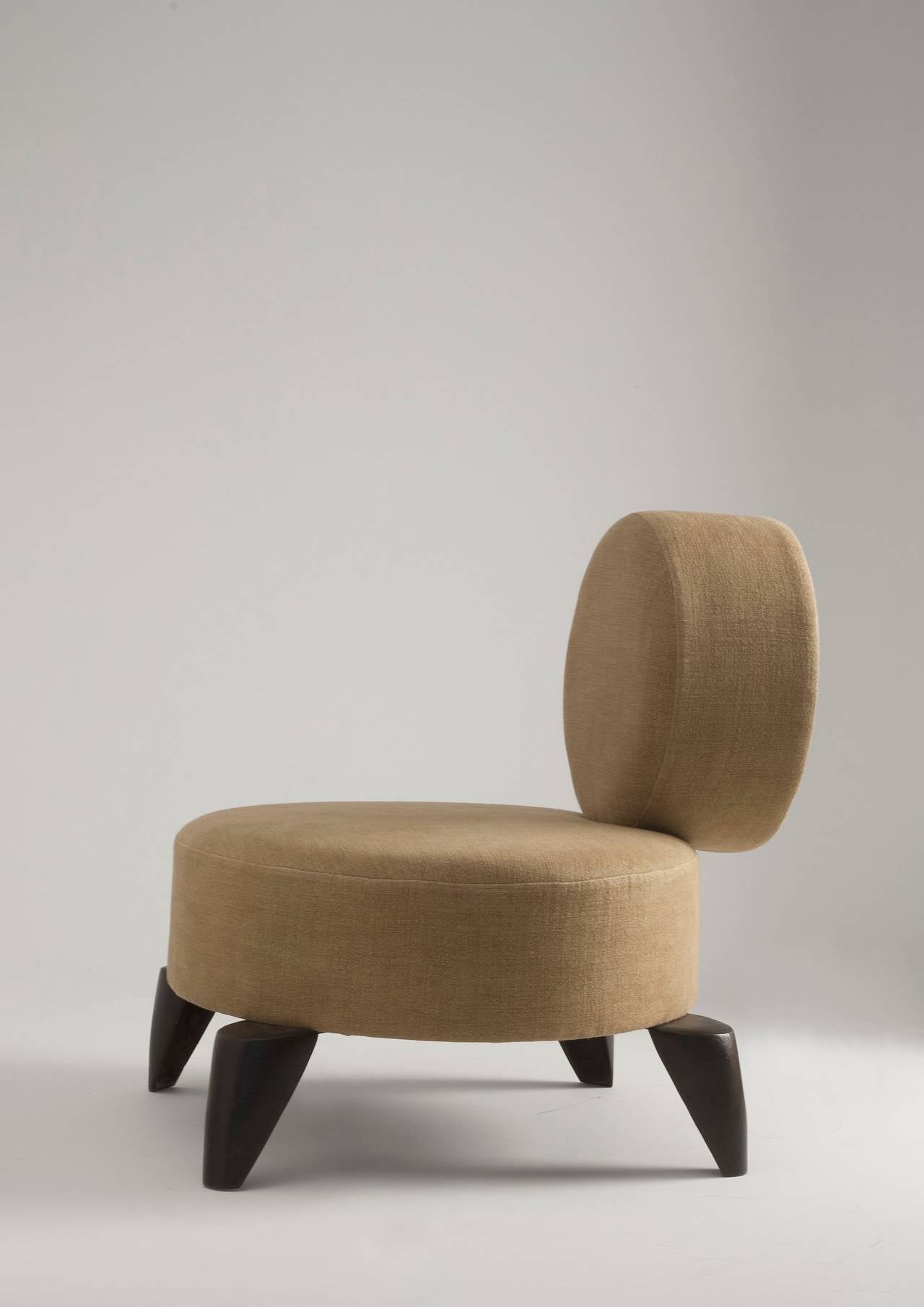 Current Upholstery is red (not as pictured)

A contemporary lounge chair of cleverly arranged geometric forms -- an oversized oval seat with a perpendicular circular back, set upon sleek patinated bronze, triangular feet.

Franck Evennou expresses