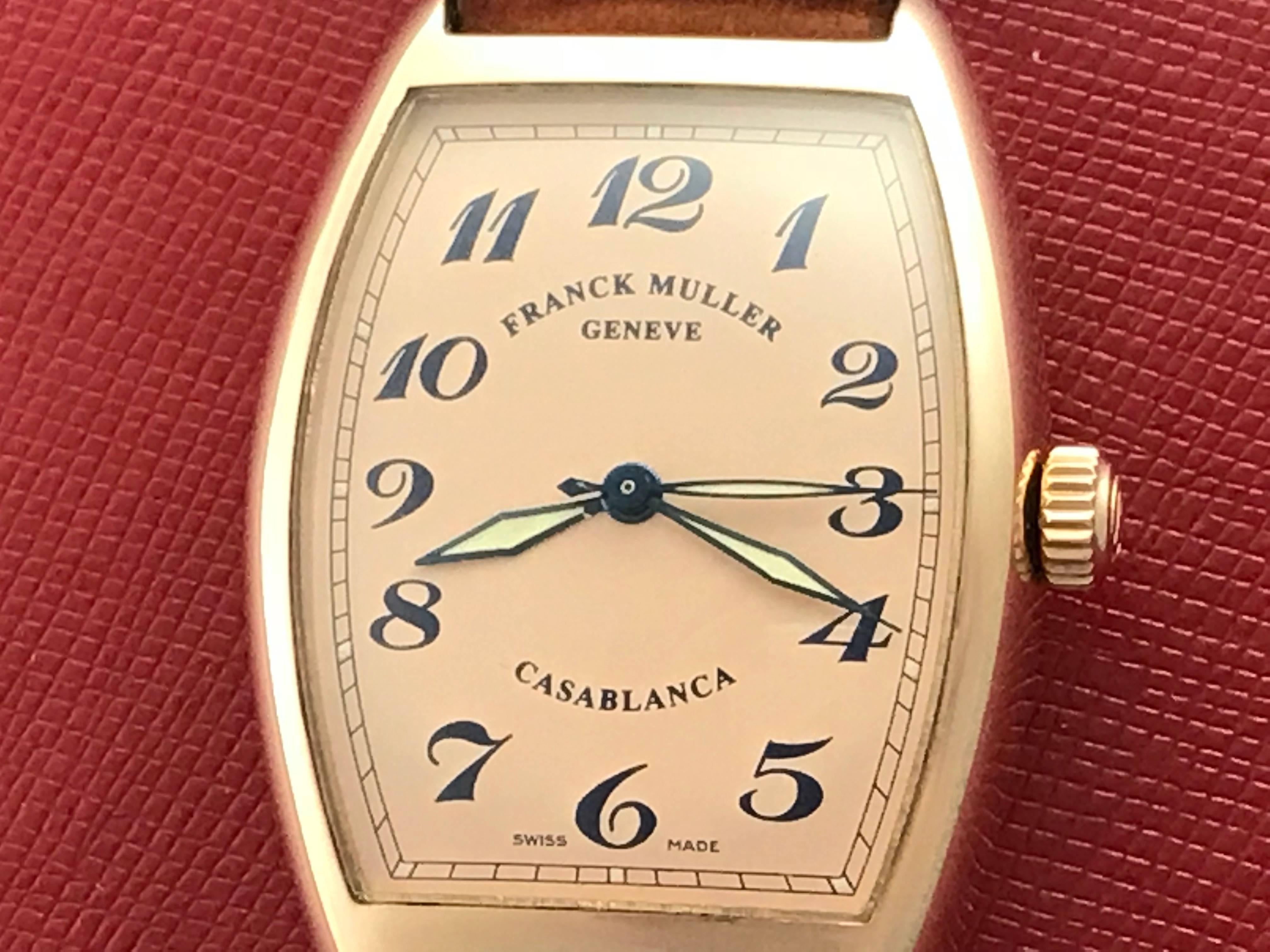 Stunning Franck Muller Men's certified pre-owned automatic wrist watch, Model H. Features a Salmon Dial with black arabic numerals, 18K rose Gold rectangular tonneau style case and brown strap with 18K rose Gold Franck Muller buckle. Measures