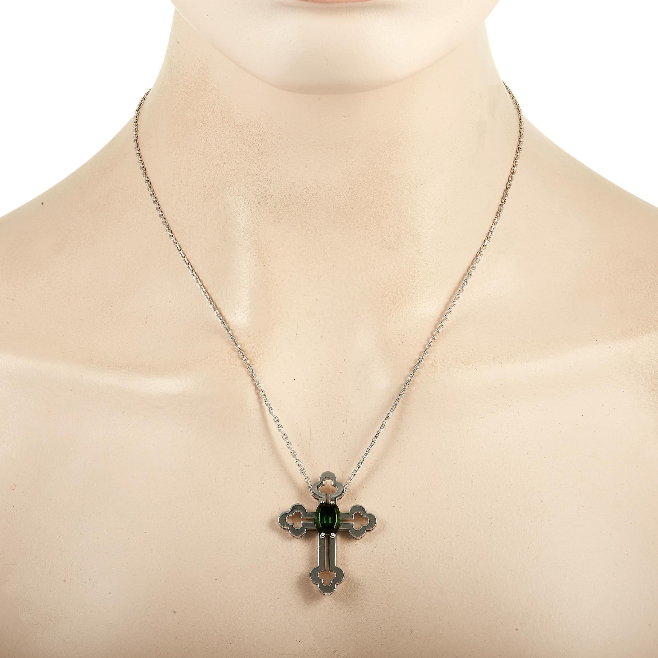 This pendant necklace from Franck Muller offers a contemporary take on a classic piece of jewelry. The 18K White Gold cross pendant measures 1.5” long, 1.25” wide, and possesses a sleek, modern aesthetic. At the center, a striking green Tourmaline