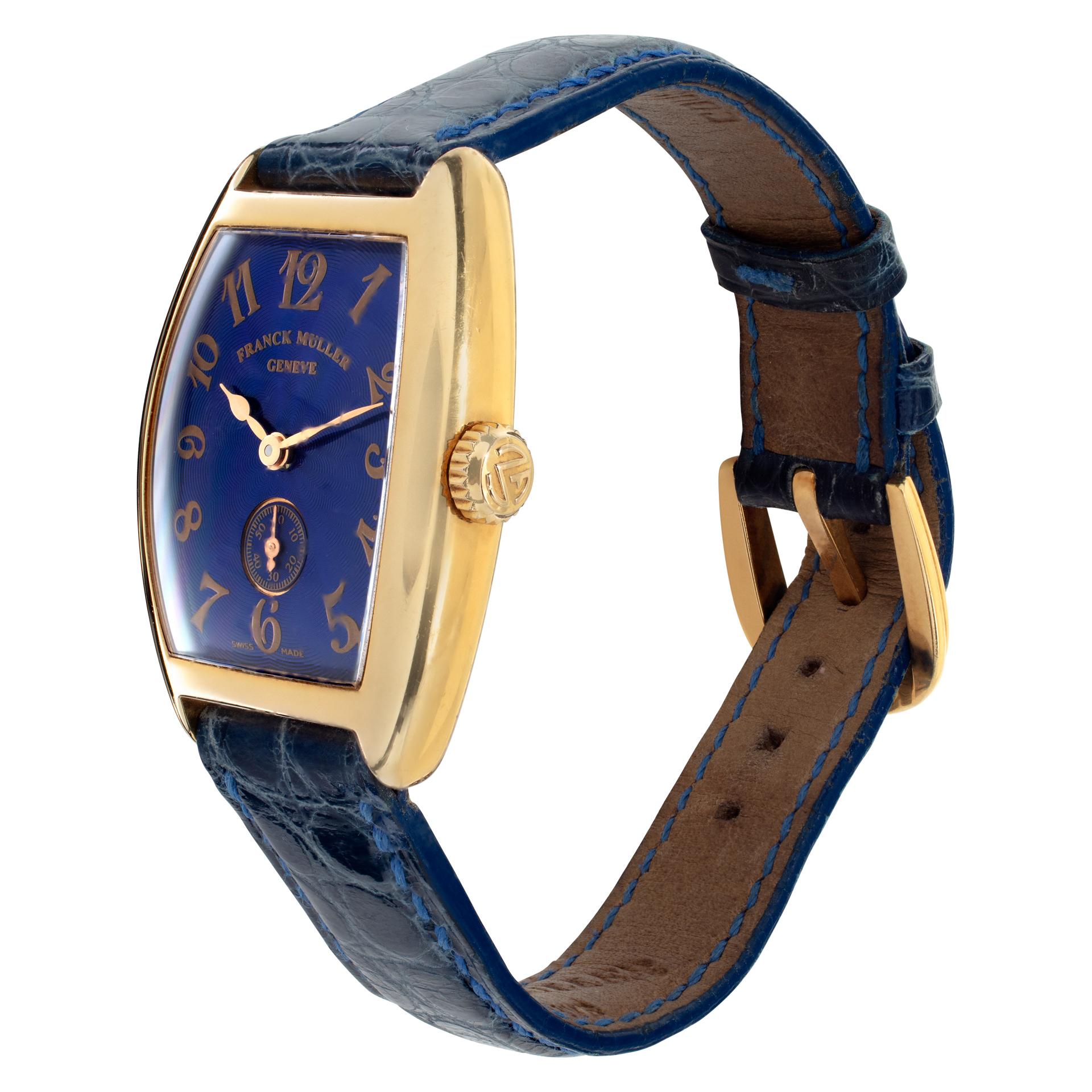Frank Muller Cintre Curvex in 18k yellow gold on a blue crocodile strap with an original 18k yellow gold Frank Muller tang buckle. Manual w/ subseconds. Measures 35mm long (lug to lug) by 25mm wide. Ref 1750 S6. Fine Pre-owned Franck Muller Watch.
