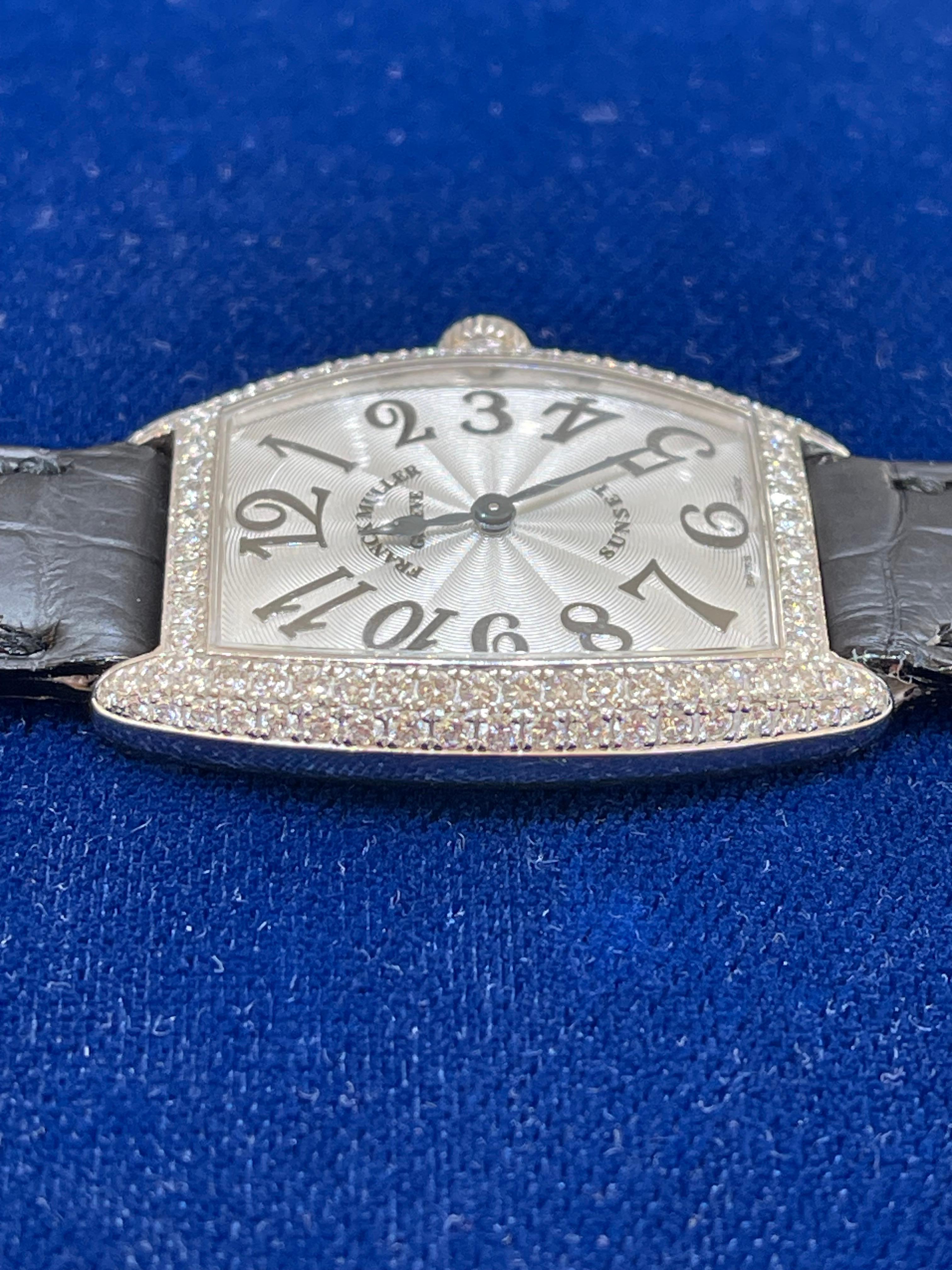 Franck Muller diamond bezel sunset watch with a sapphire crown. The original leather strap is included, the buckle and the case are both 18k gold. The length measures 8 inches,  case measures 27.6x28.3 and total weight is 39.7 grams. 