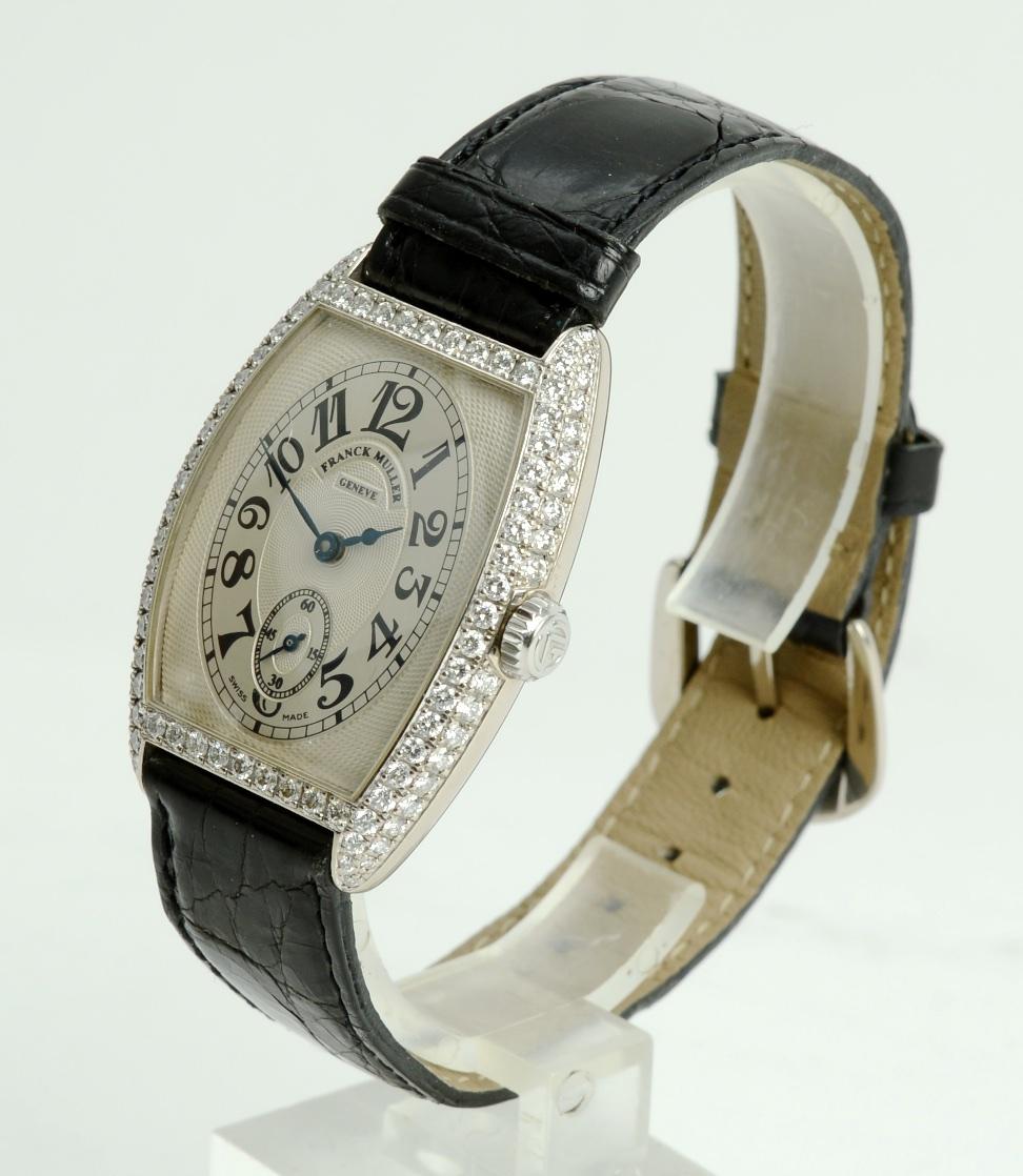 Franck Muller, Ladies Cintree Curvex Chronometro, 18K White Gold and Diamonds, Manual Wind. The case is 39mm x 31mm, in 18K white gold, and is tonneau shaped, with diamond-set bezel, sides, and lugs, with a screw-down back, No. 136. The dial is