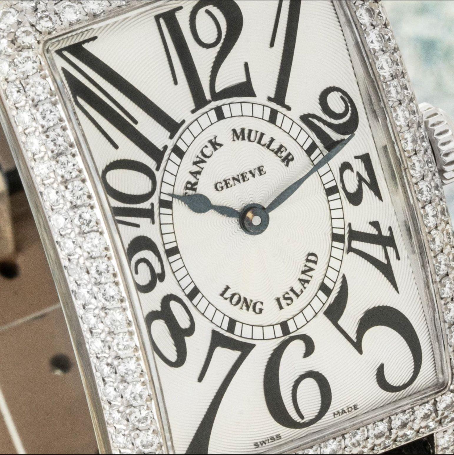 A 26mm Long Island wristwatch crafted in white gold by Franck Muller. Featuring a silver guilloche dial with arabic numerals, blued sword shaped hands and a white gold bezel set with round brilliant cut diamonds.

Equipped with a generic black