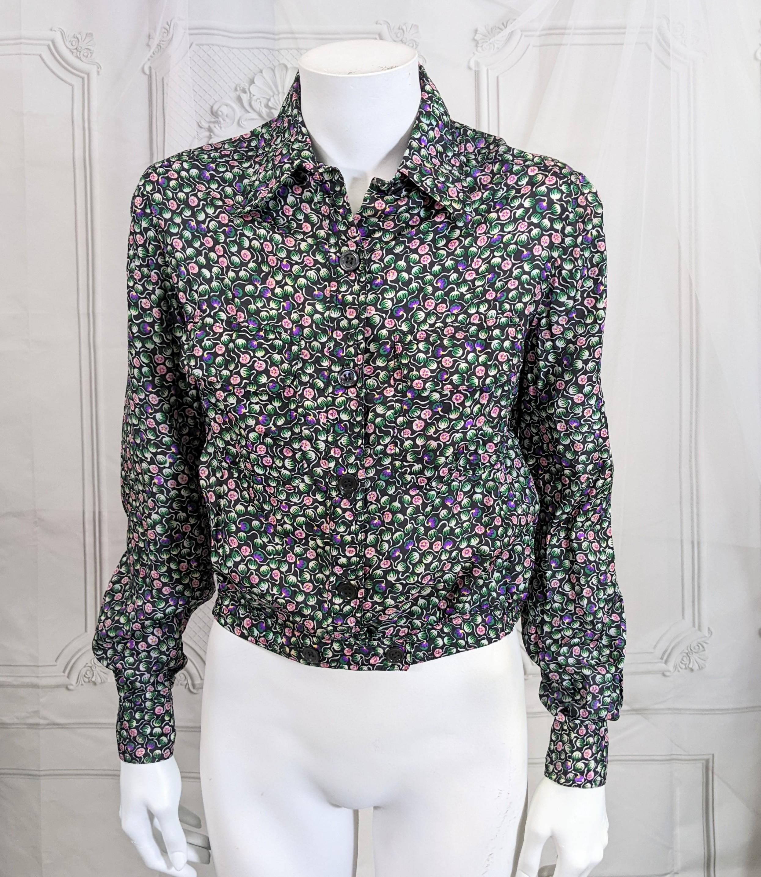 Franck Olivier Floral Print Bomber Blouse from the 1970's.  A lovely Liberty style floral silk shirting is used in a cool bomber jacket style but is actually a blouse. 2 button pockets with double button waistband. 
1970's France.  Marked size 40