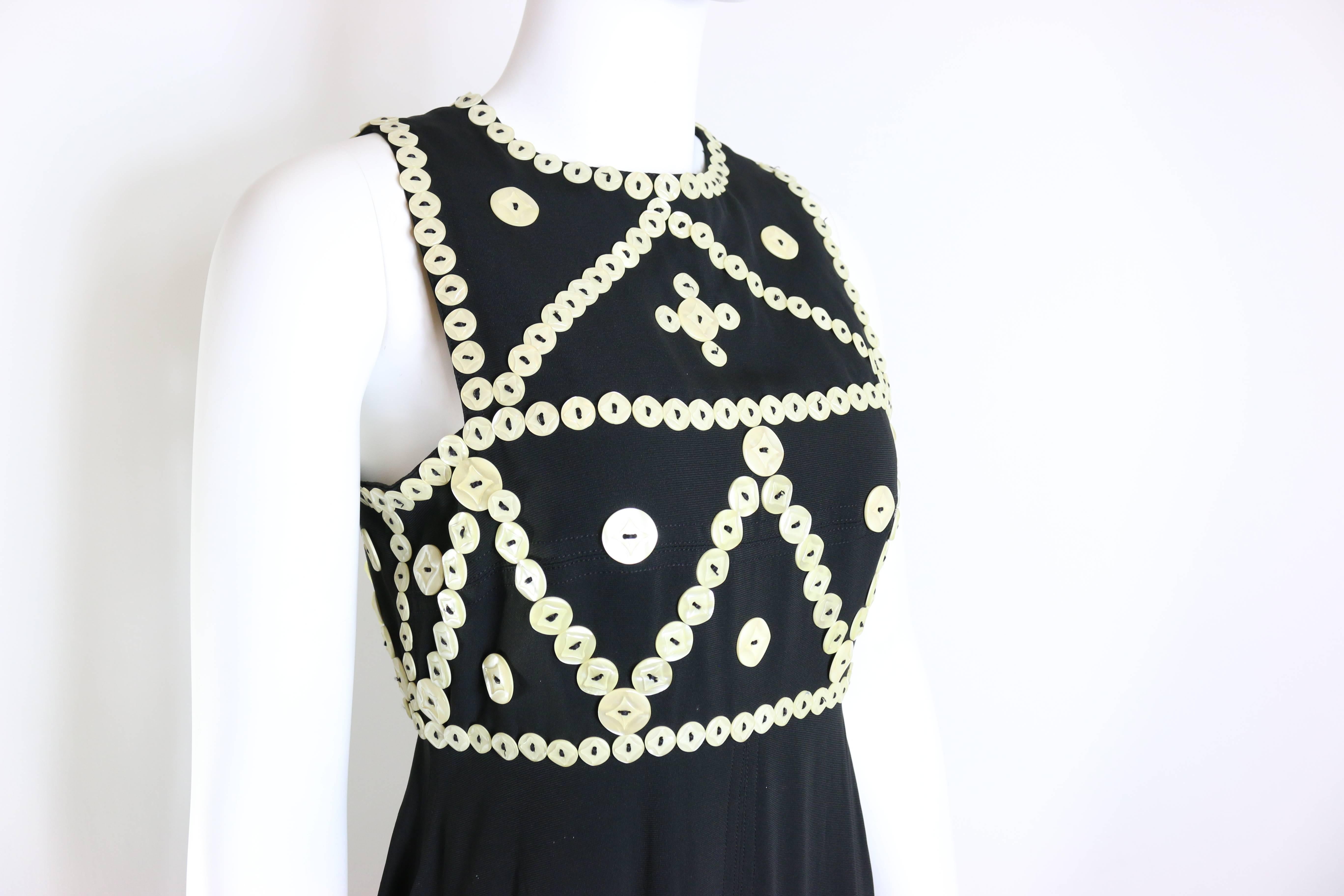 - Vintage 90s Frank Sorbier haute couture black embroidered mother of pearls button maxi dress. Elegant, once and only design and only available in OnceStyle. 

- Embroidered white shell buttons. 

- Height: 148cm I Shoulder: 6cm I Bust: 40cm I
