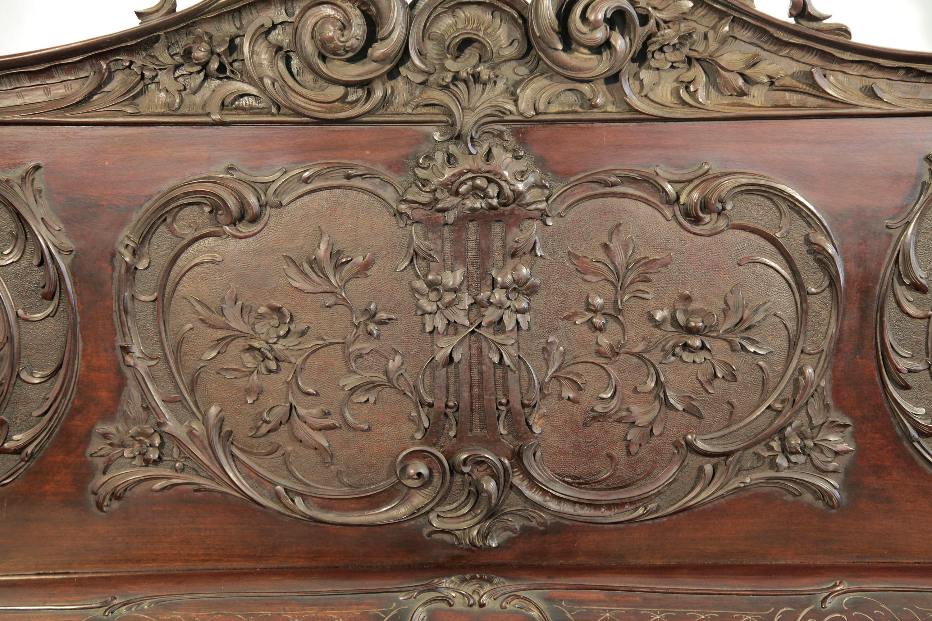 Francke upright piano with a mahogany case. Entire cabinet features Rococo style, ornate carvings in high relief.
The carved, front panel features a central lyre surrounded by flowers, foliage and acanthus. The piano fall has carved latticework and
