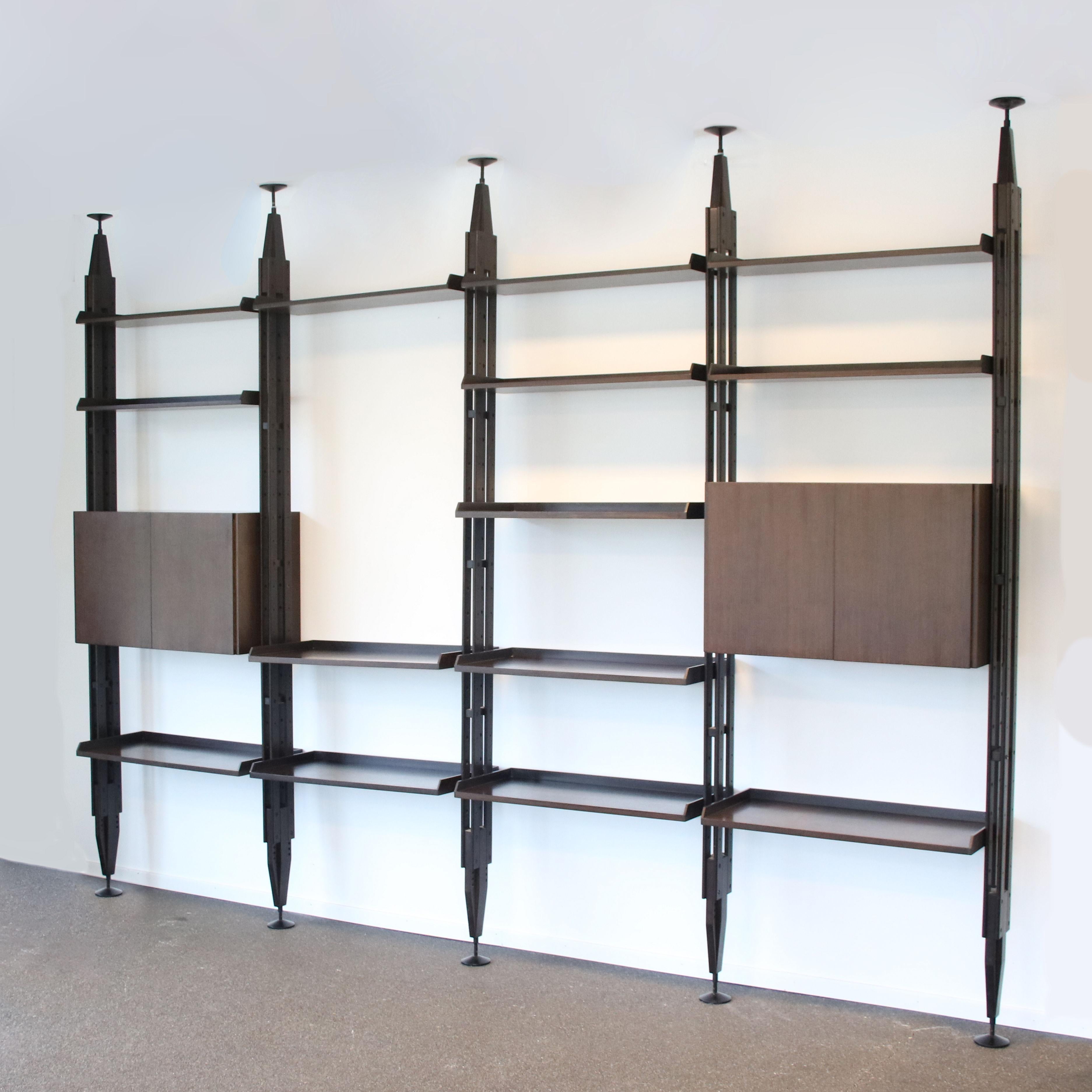 A beautiful, 4-unit wide shelving system desined by Franco Albini, manufactured by Poggi in Italy around 1960.

This large piece is made of high quality dark stained wood with brass details. It excels in elegance and has a beautiful and highly