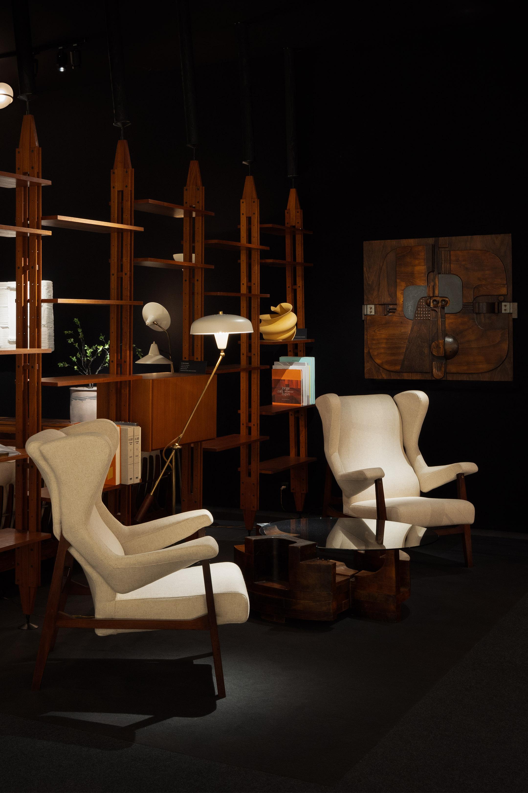 Rare early versions of Fiorenza lounge chairs designed by Franco Albini and manufactured by Arflex in Italy in 1956. These chairs are made of solid walnut and show a unique square architectural design with slightly angled feet and horizontal