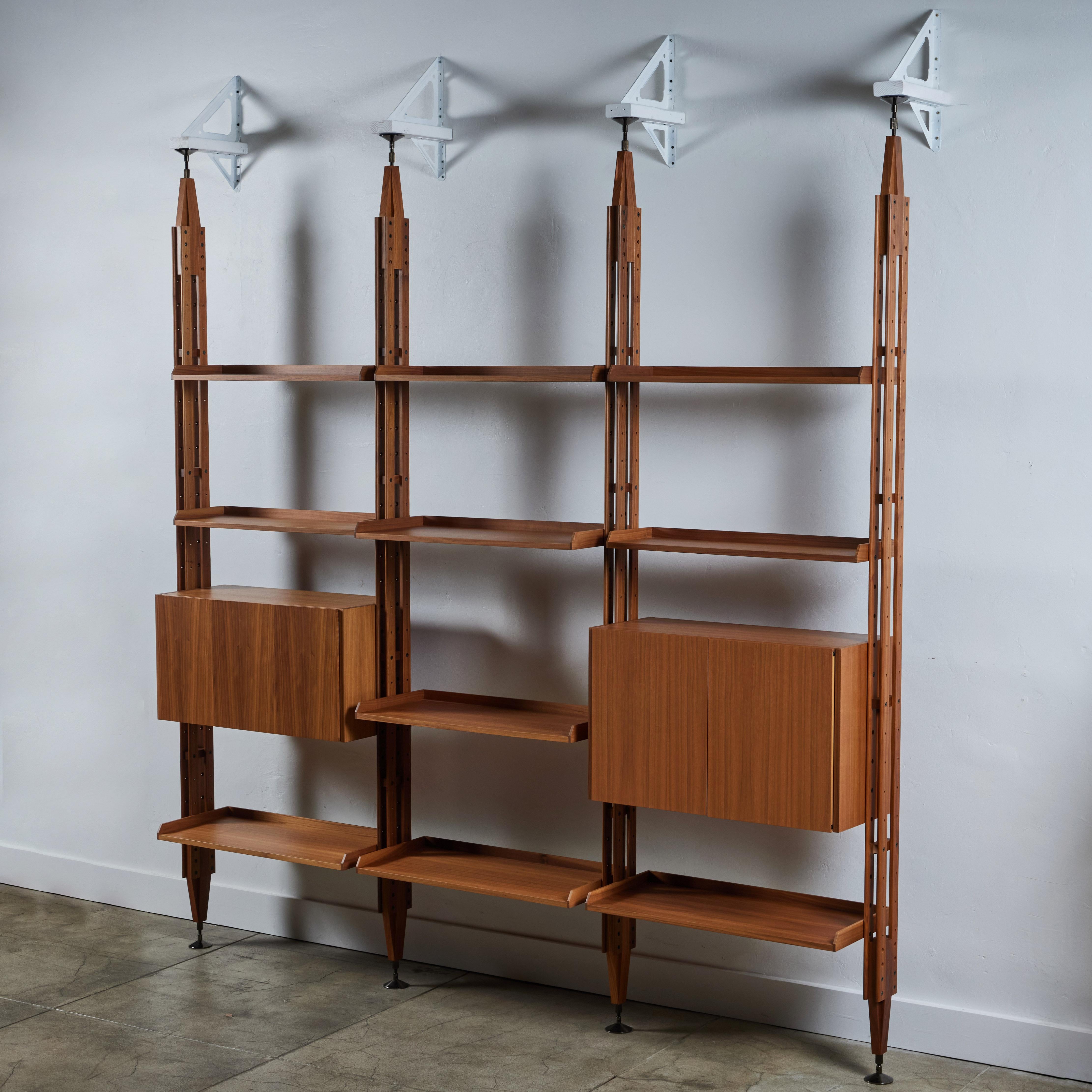 Franco Albini wall unit for Cassina, c.2010s Italy. This modular shelving system, first designed in the 1950s, was relaunched in 2008 and features three bays with teak bars and ten teak adjustable shelves. Also included are two cabinets for storage.