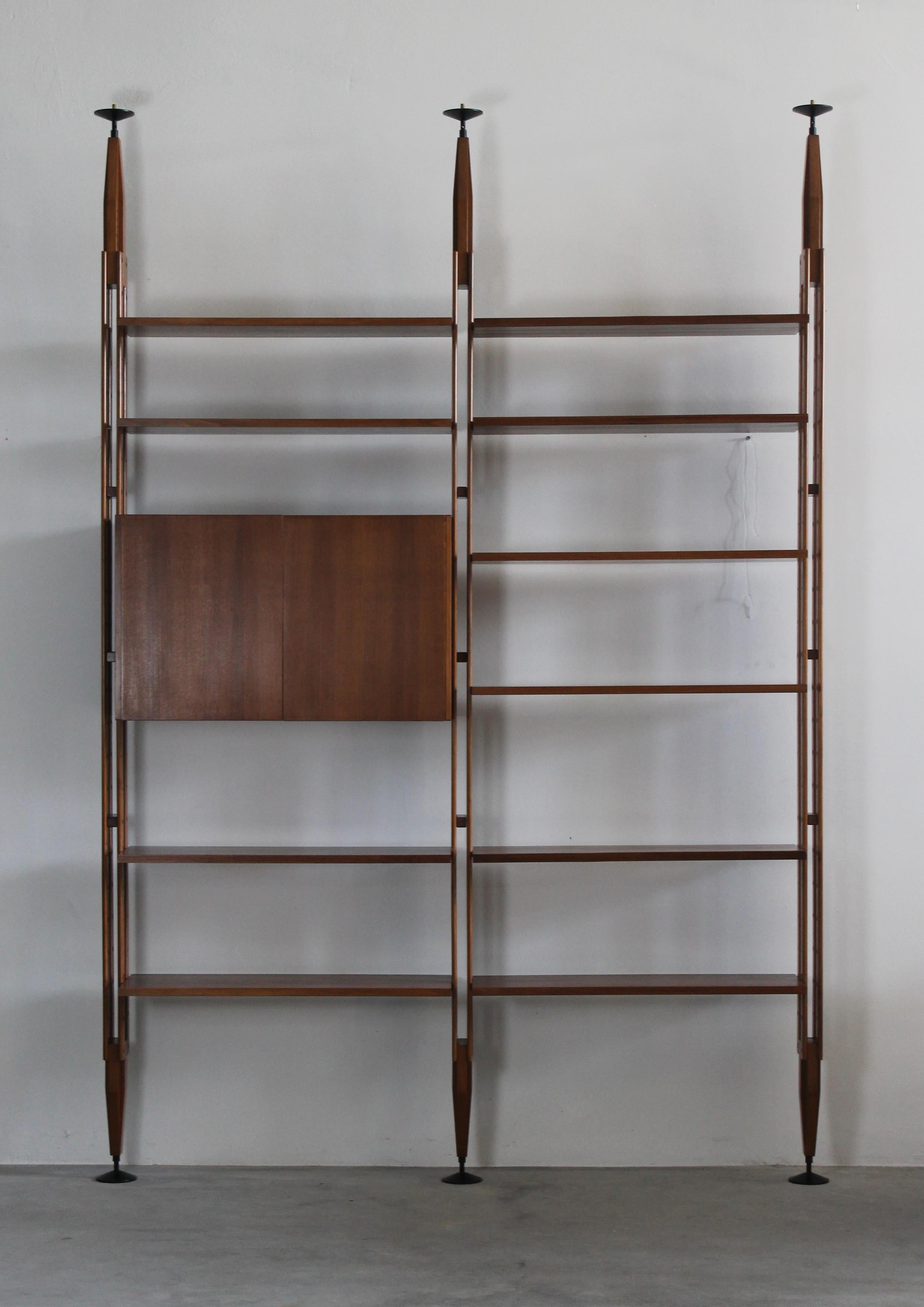 LB7 modular bookcase composed of two modules with one storage unit and shelves, the bookcase is realized in solid veneered teak wood, and black lacquered metal details. 

Designed by Franco Albini and produced by Poggi Pavia, 1956, Italy.